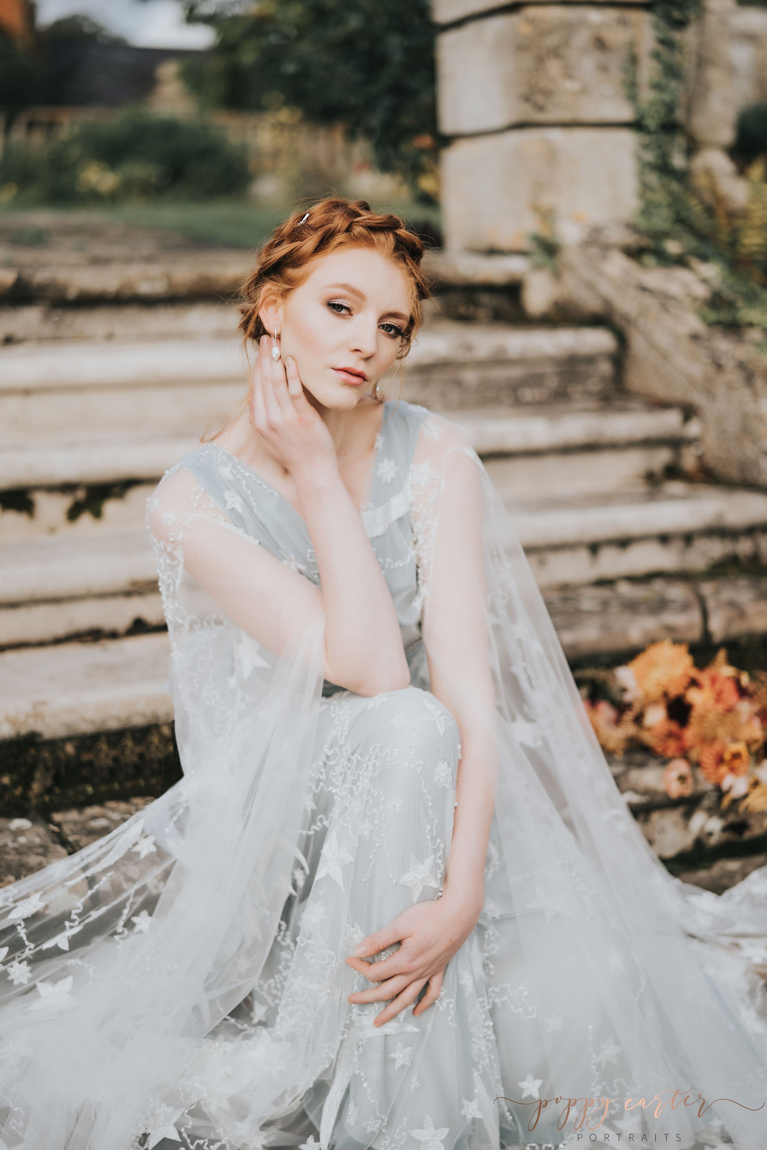 Autumn bride sitting on stone steps