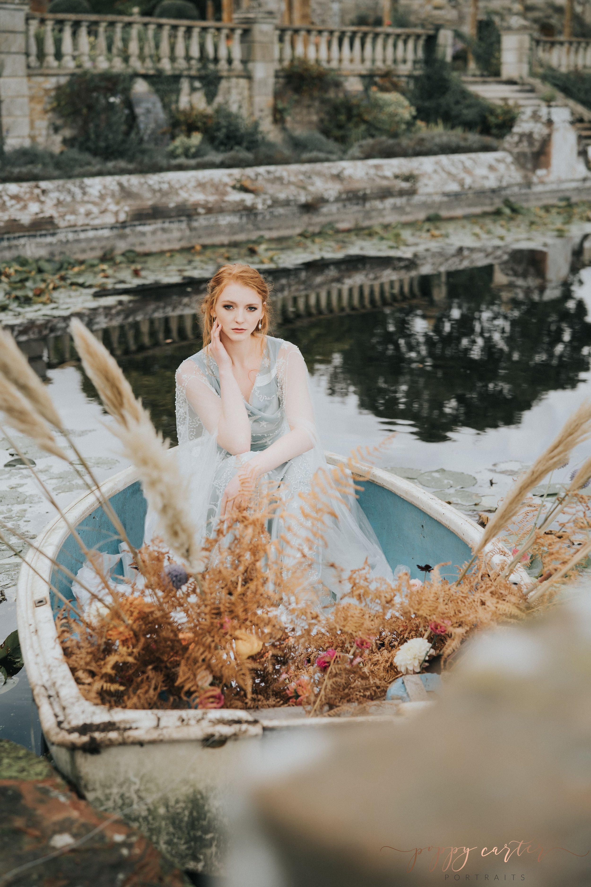 Autumn bride sitting in rowing boat