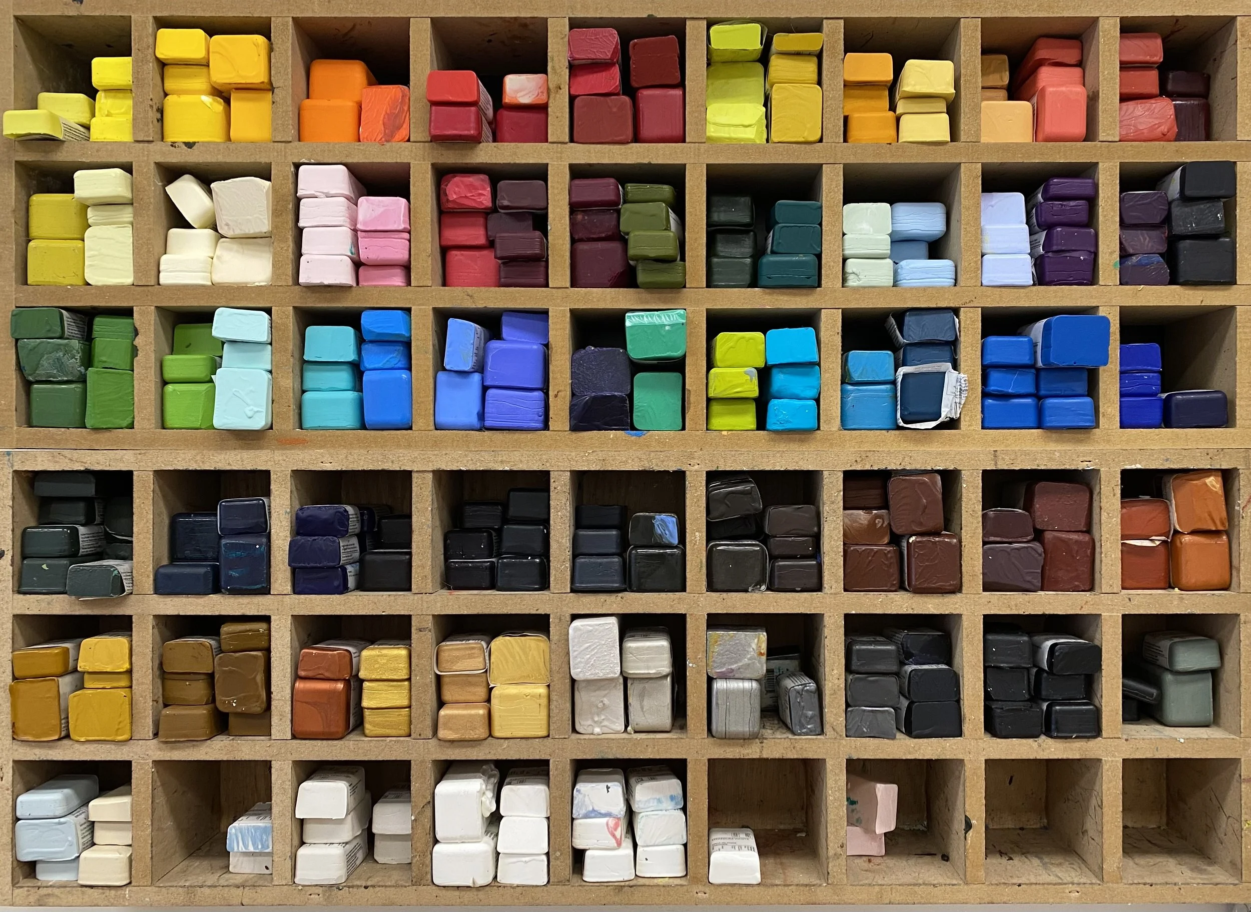 Wooden shelf with colorful encaustic paint.