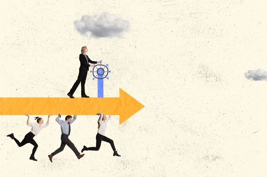 Businesspeople working together to move an arrow forward, with one person at the steering wheel and clouds in the sky.
