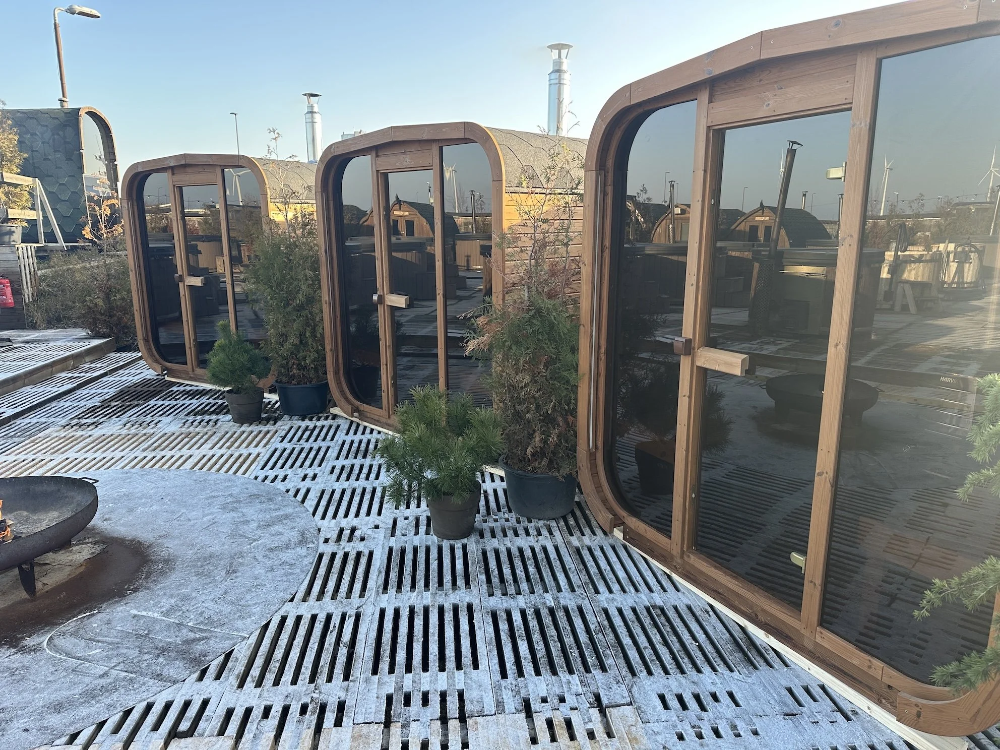 3 glasswalled saunas next to each other  in the snow