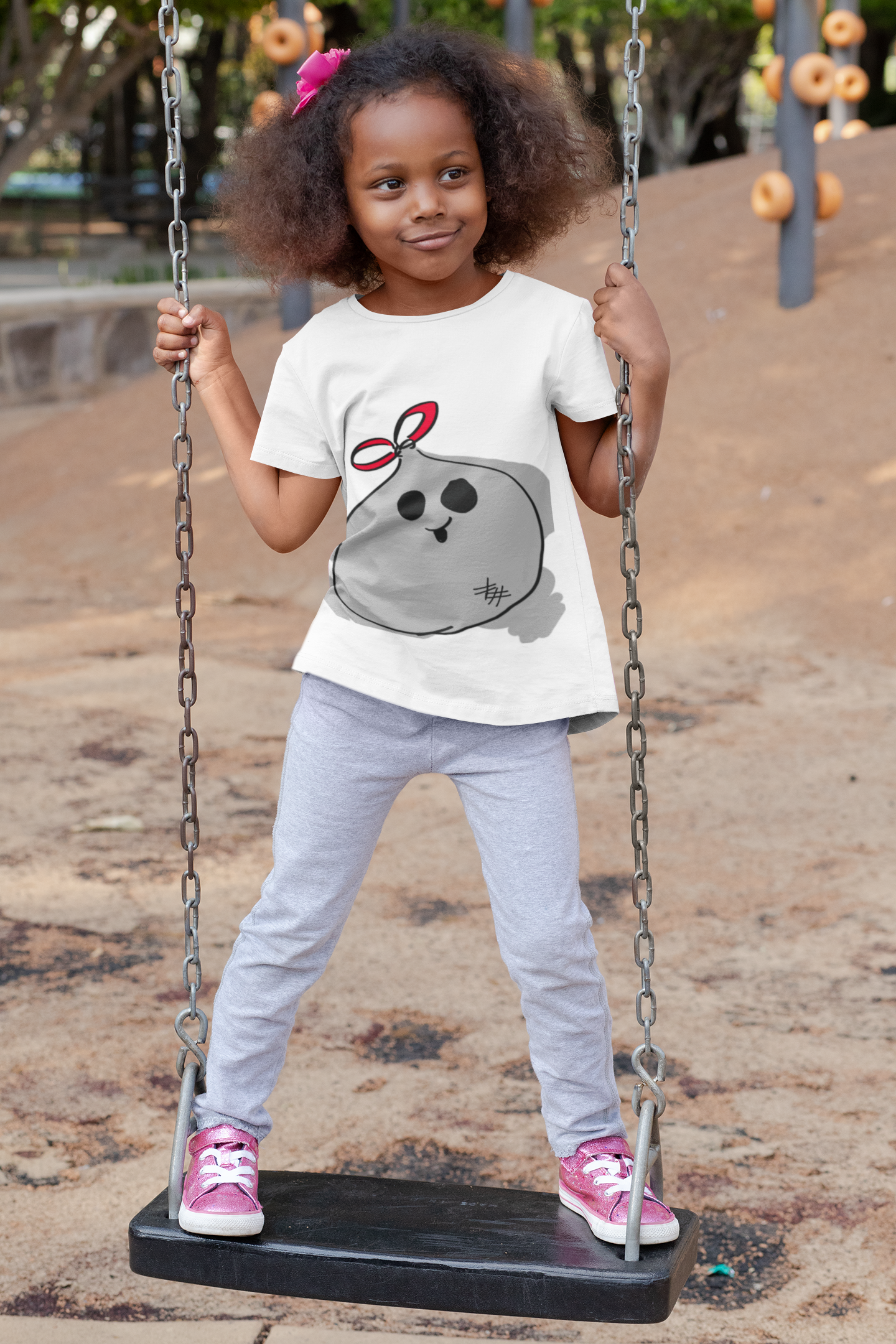 t-shirt-mockup-of-a-playful-girl-standing-on-a-swing-32179.png