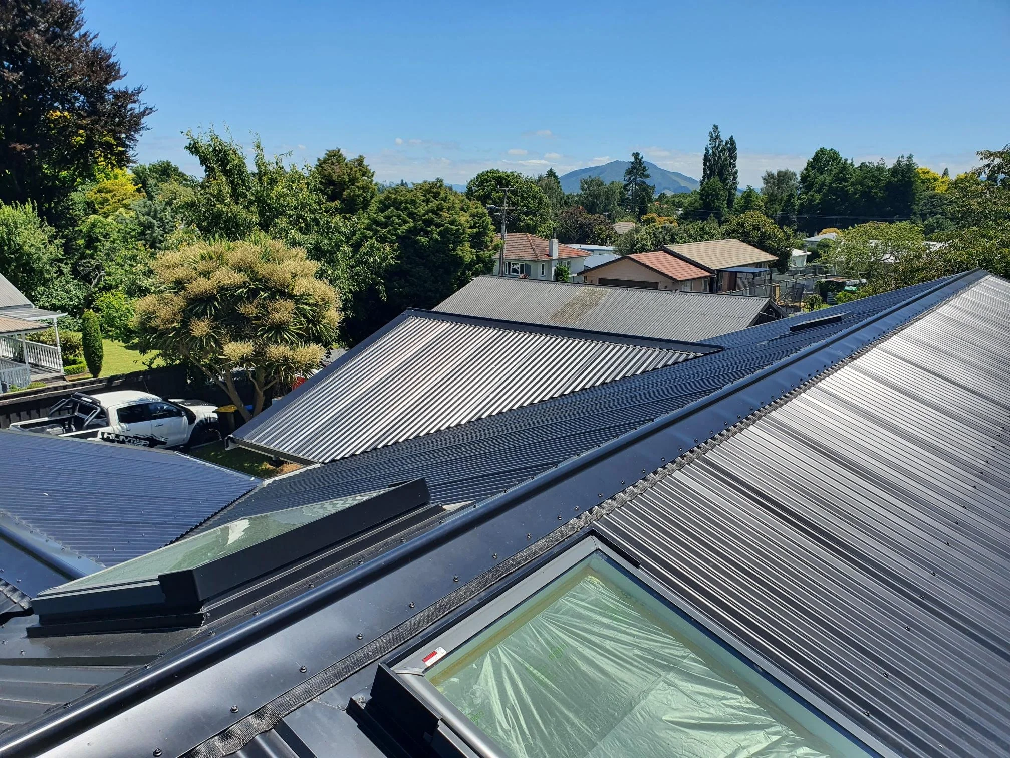 Skylight installs on a corrogated long run roof.