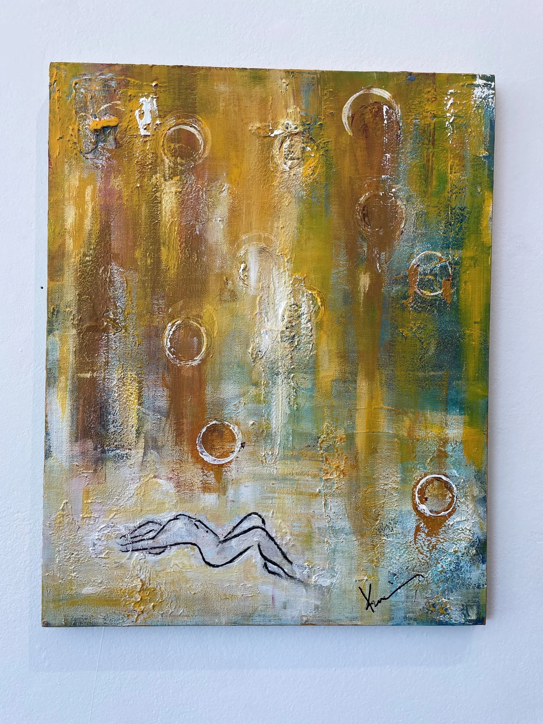 An abstract painting on a canvas with warm tones of yellow, brown, and white, featuring circular shapes and a sketch of a mountain range at the bottom. The artist's signature is visible at the lower right corner.