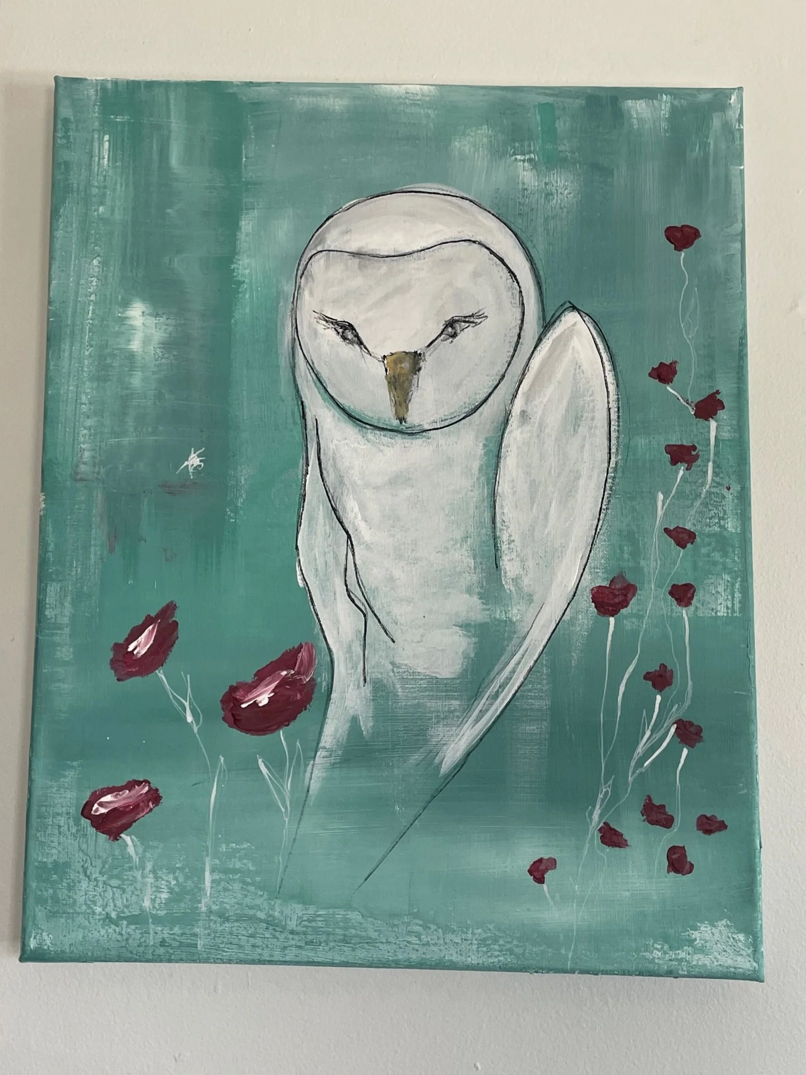 A painting of a white owl with closed eyes on a teal background, with red flowers on the right side and scattered around.