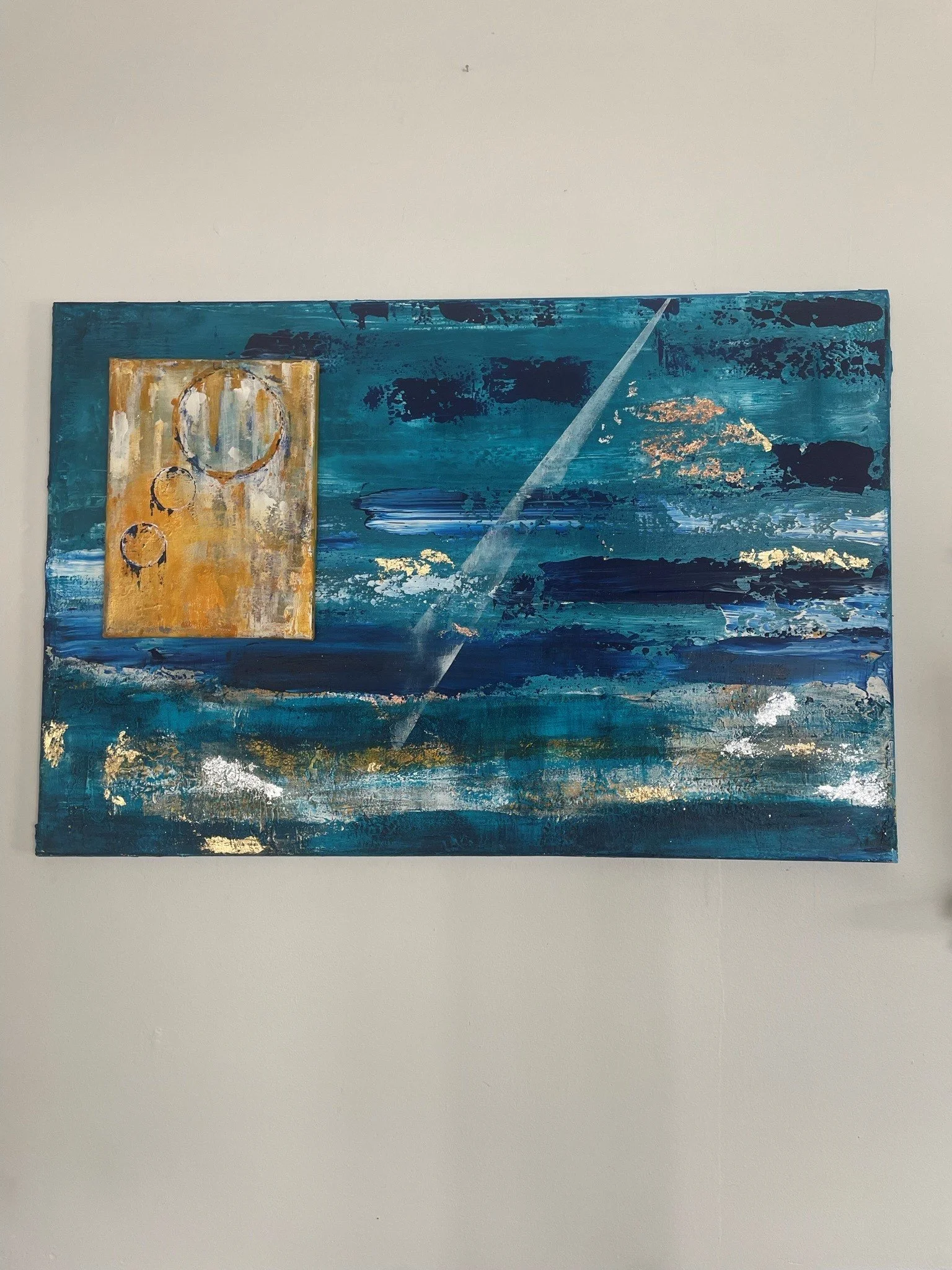 Abstract painting with blue, gold, white, and black colors, featuring circular and streaked patterns.