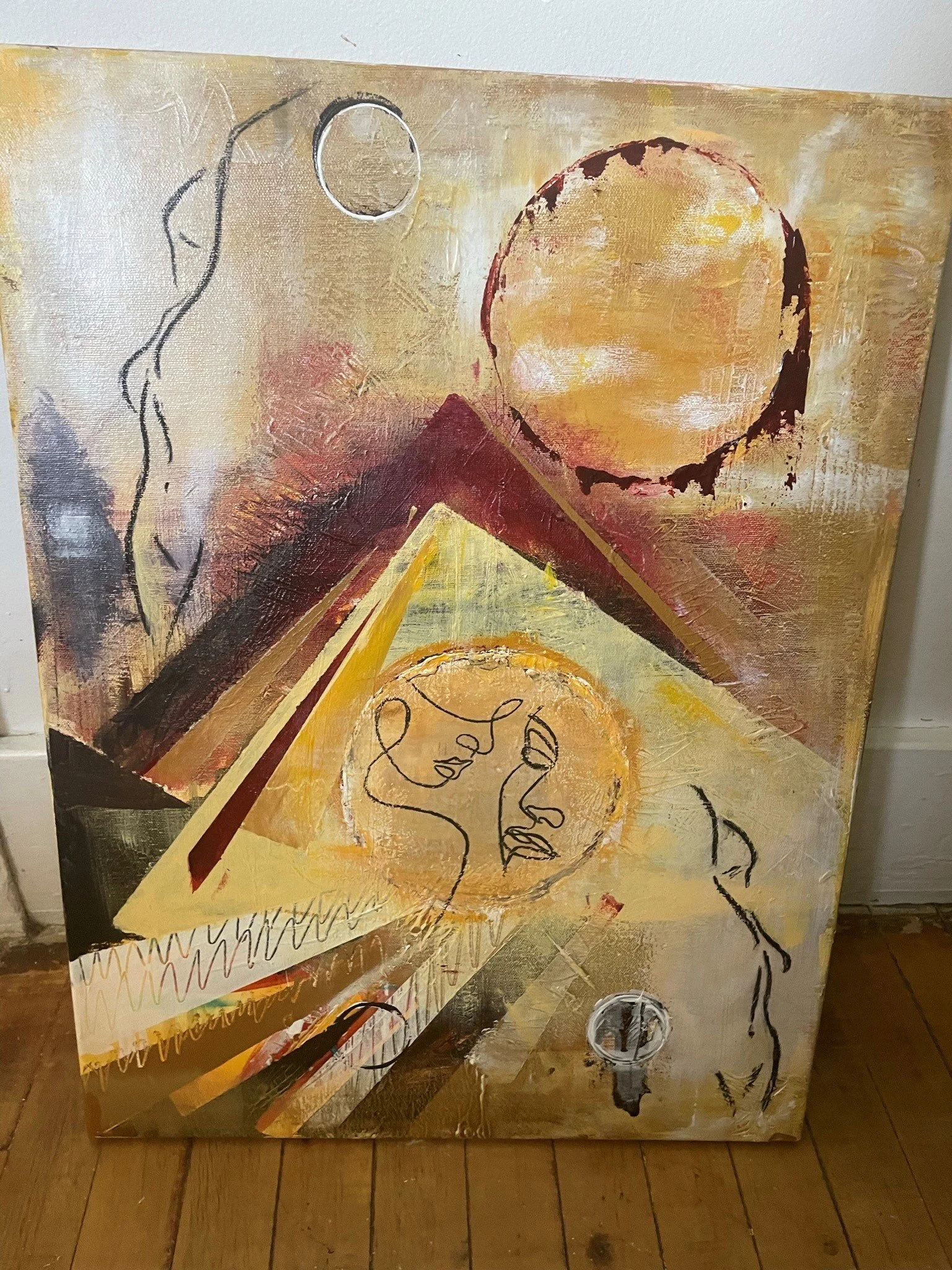 A mixed media abstract painting on canvas showcasing a large yellow-orange circle and a smaller white circle, with silhouette-line drawings of a face and a hand, and geometric shapes and textured brushstrokes in gold, black, red, and white.