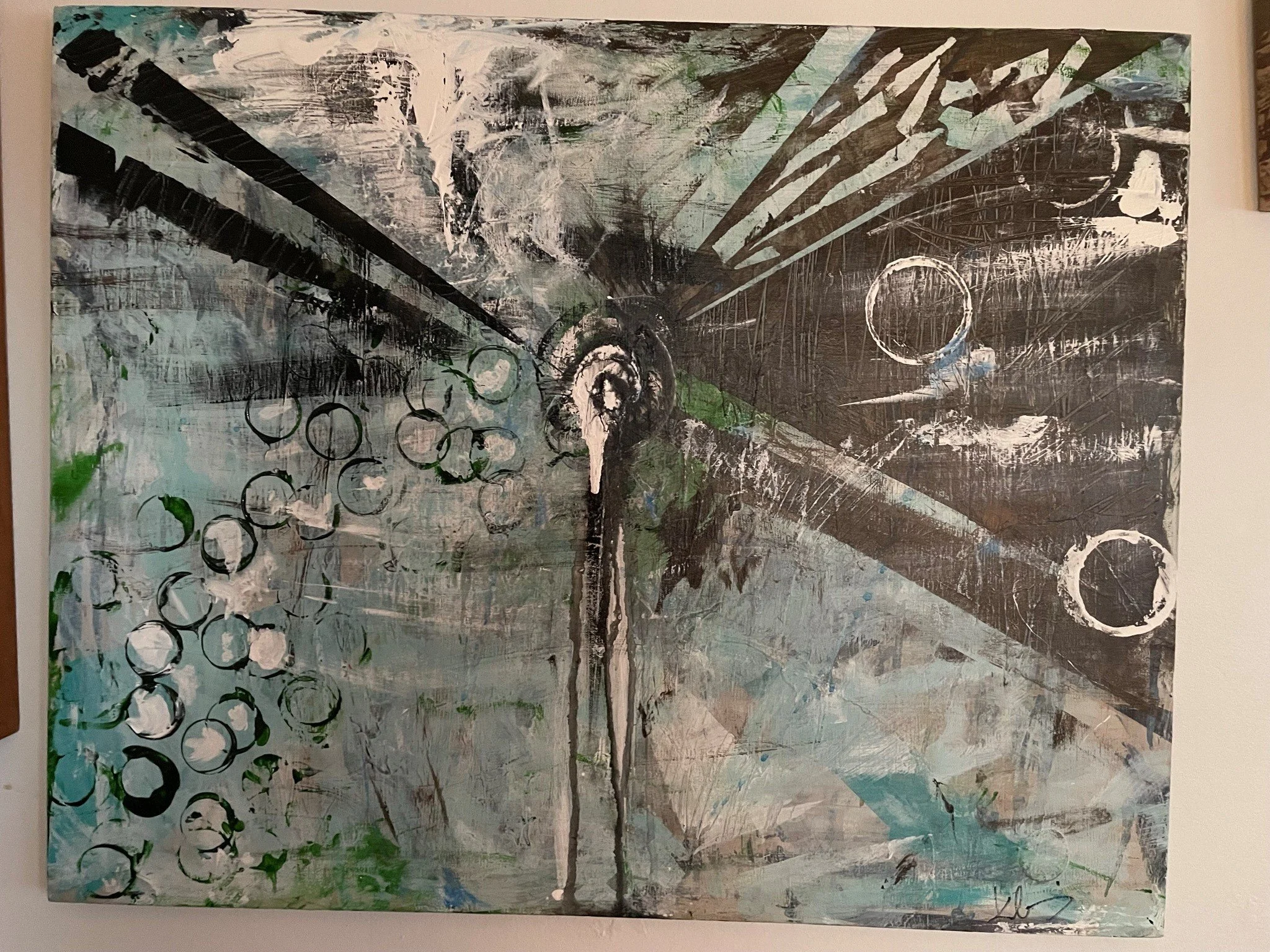 An abstract painting featuring a tree with multiple circles on the left side and diagonal streaks of paint crossing the canvas. Dark, black, and white colors dominate the artwork, with touches of green and blue accents.