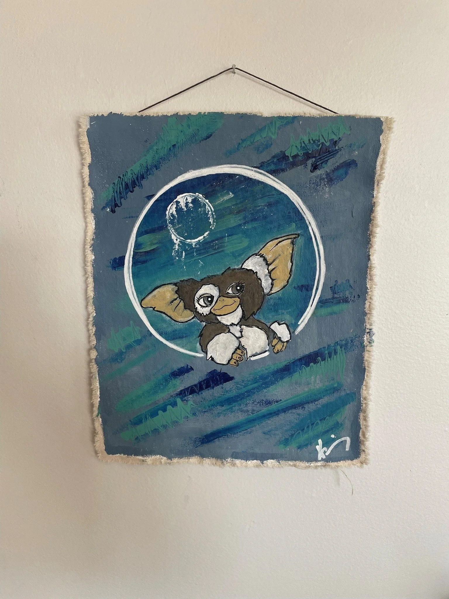 A painting of a mouse with large ears and big eyes, seated under a starry night sky with a full moon and green grass, also featuring a white circle and signature at the bottom.