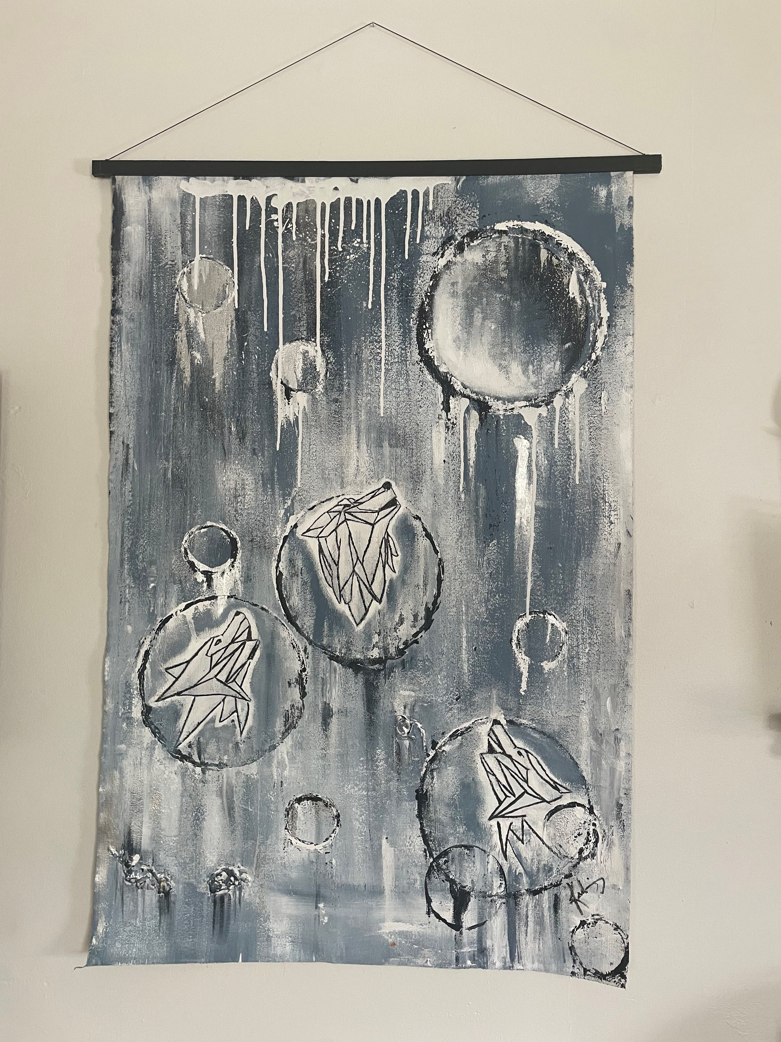 Abstract black and white painting with circles, some containing leaf or geometric patterns, on a gray background with dripping paint effects.
