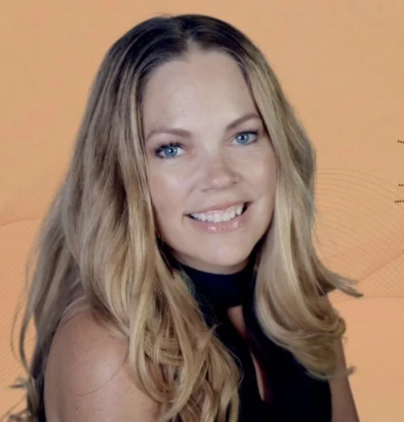 A woman with long blonde hair and blue eyes smiling at the camera.