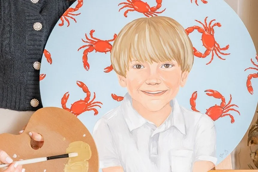 young boy custom painted portrait with a nautical crab painting in the background. 