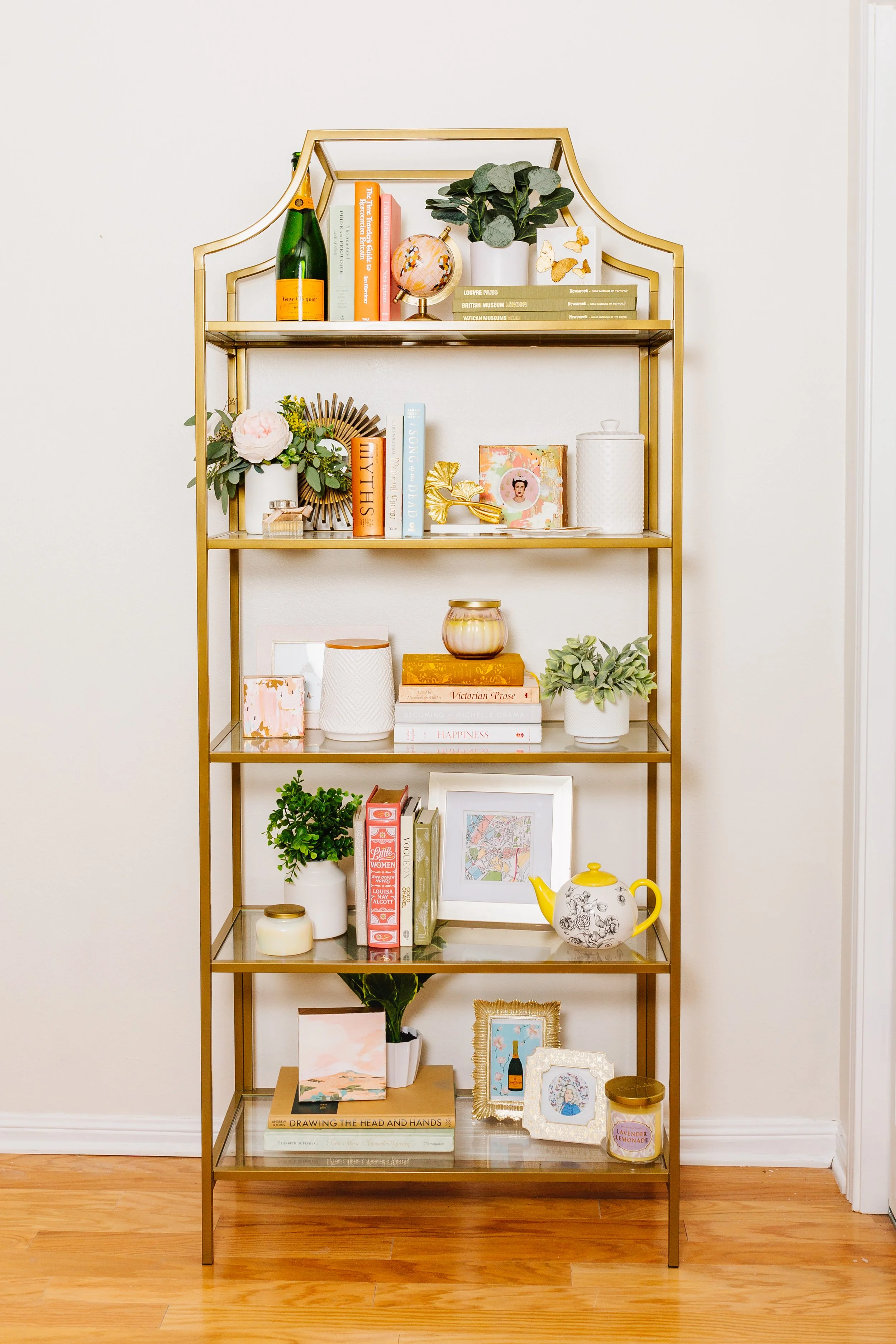 bookshelf filled with decor items and small giftable artworks. 