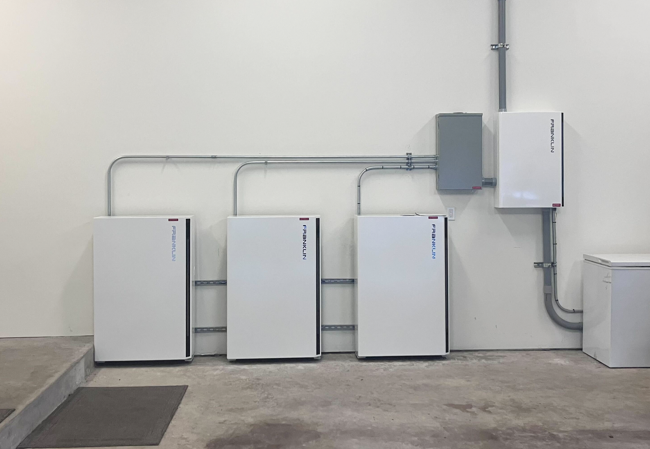 Blossom Solar installed FranklinWH aPower 2 Battery system, with three aPower 2 packs and aGate in image from garage.