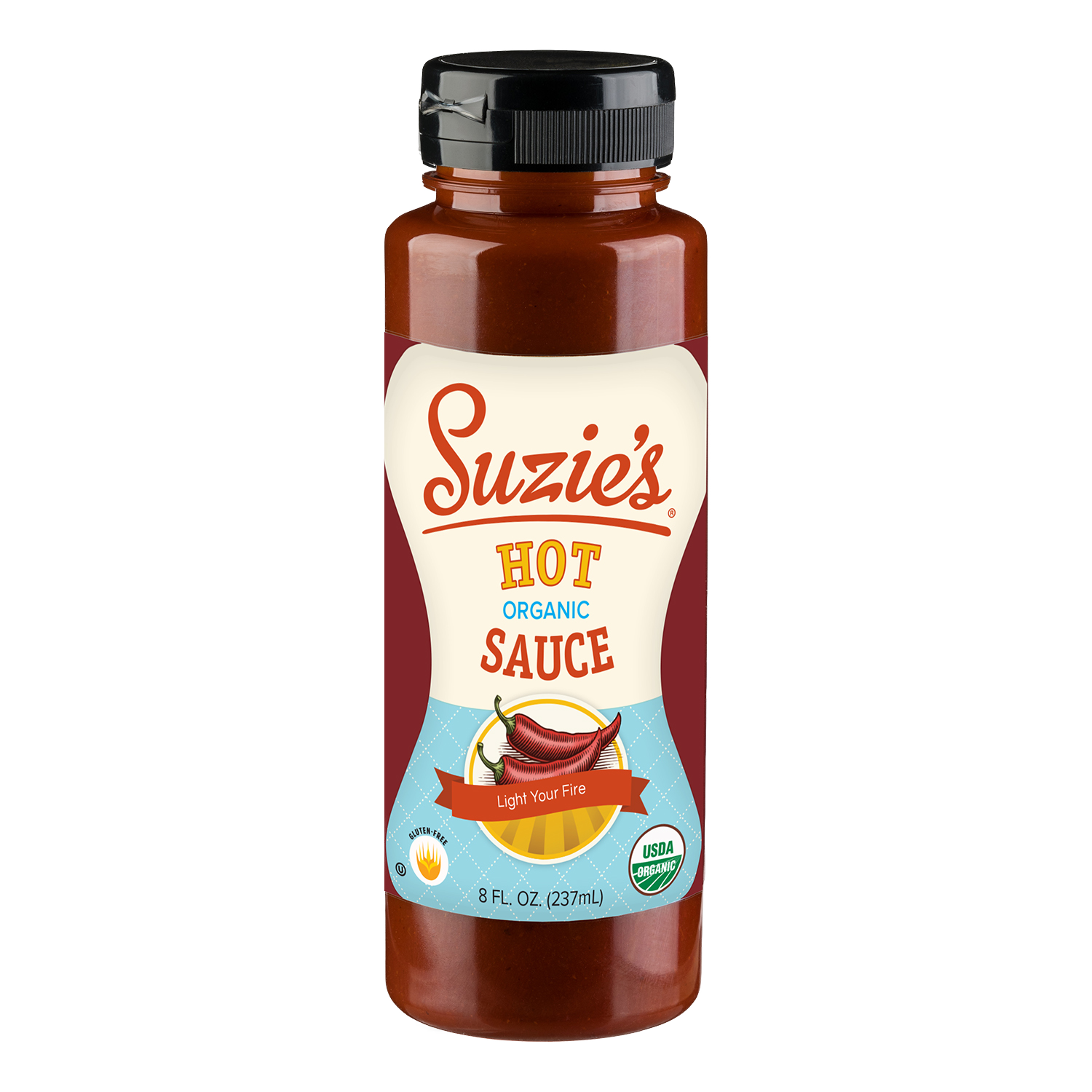 Bottle of Suzie's Organic Hot Sauce with a label indicating it is organic, gluten-free, and USDA organic, featuring two red chili peppers and a lemon, with the tagline "Light Your Fire".