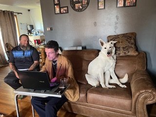 Tiye, undeterred by the lack of fingers, diligently creates the world’s greatest logo, destined to inspire change one person at a time and embodying the fantastic grace of Rev and CiCi, who supervise with unwavering care. While Bell waits patiently t