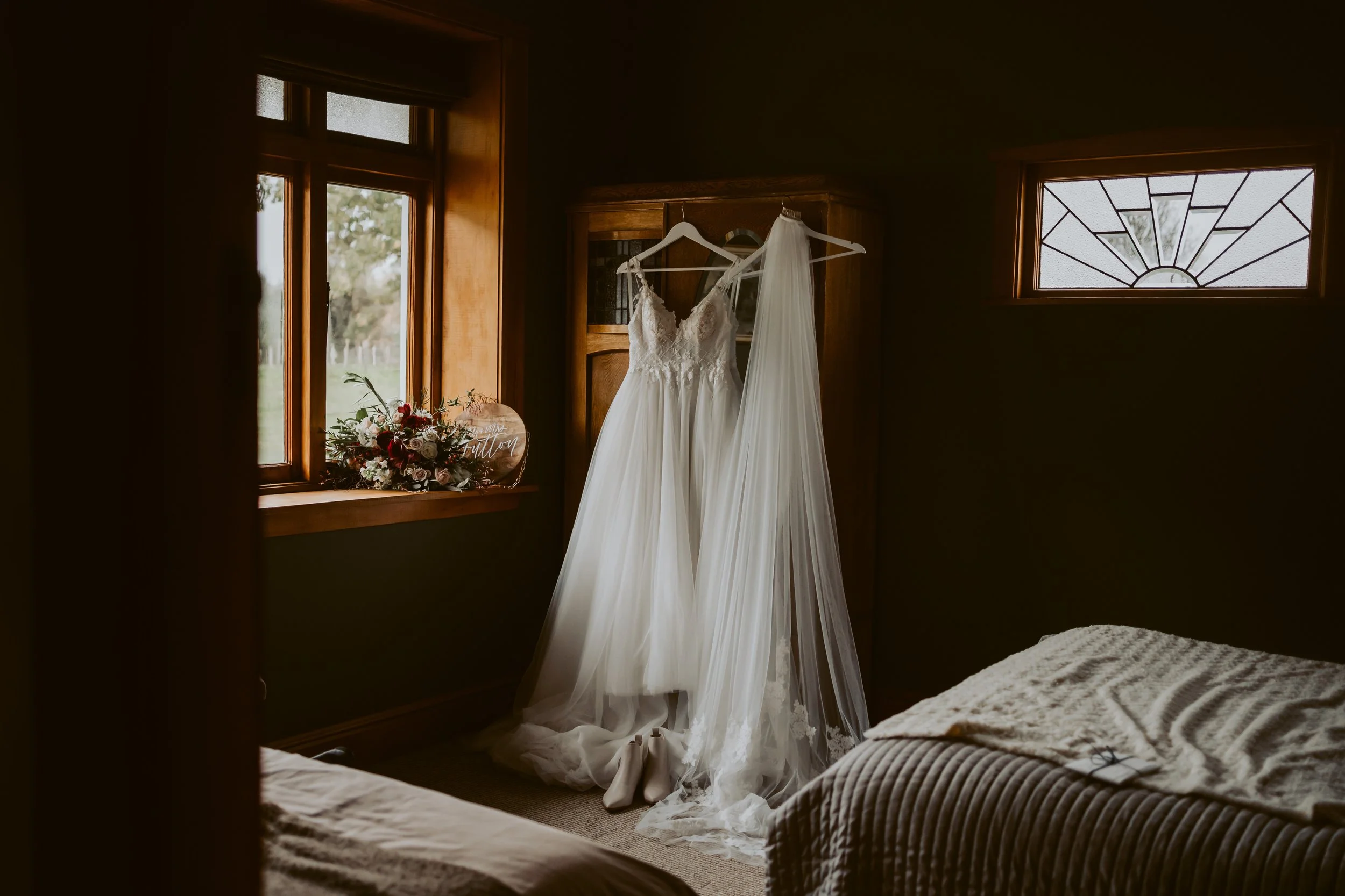 wedding dress hanging up inside Makoura lodge wedding accommodation