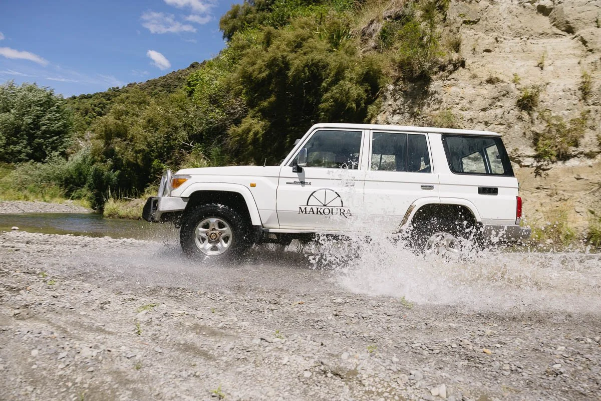 A 4x4 ute transversing a river at Makoura Lodge 4x4 training track