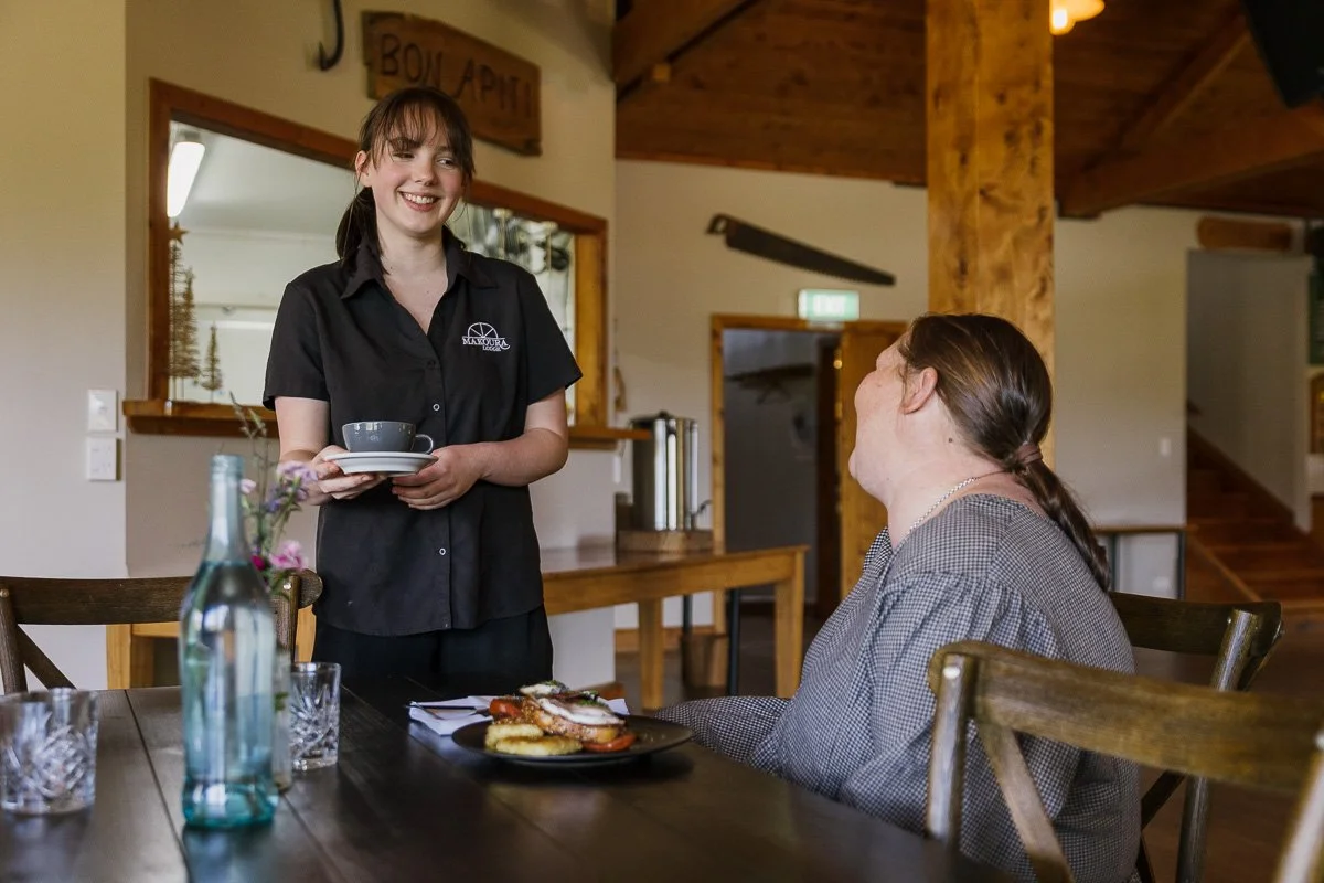 staff member serving guest a coffee at makoura lodge conference venue