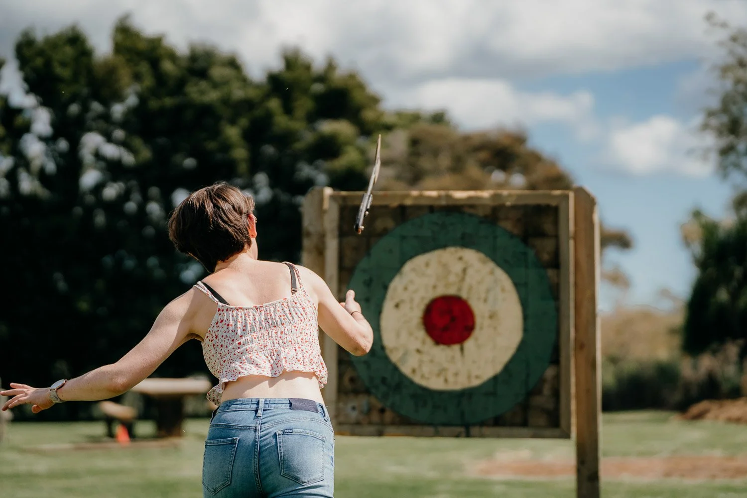 Girl throwing an axe at a christmas function at Makoura Lodge