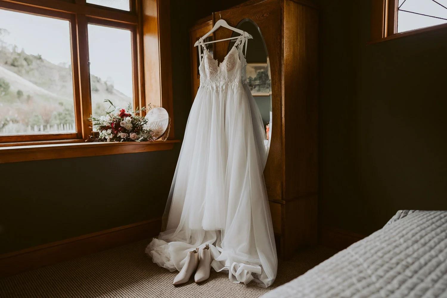 wedding dress hanging up inside Makoura lodge wedding accommodation