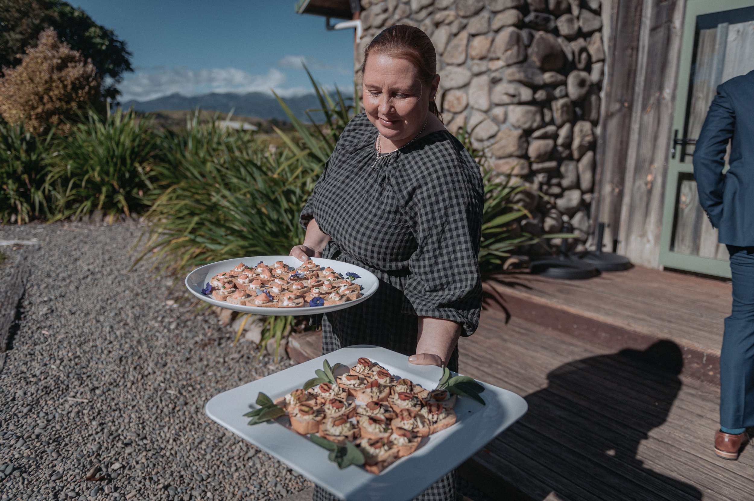 Staff handing canapes at wedding ceremony Makoura Lodge