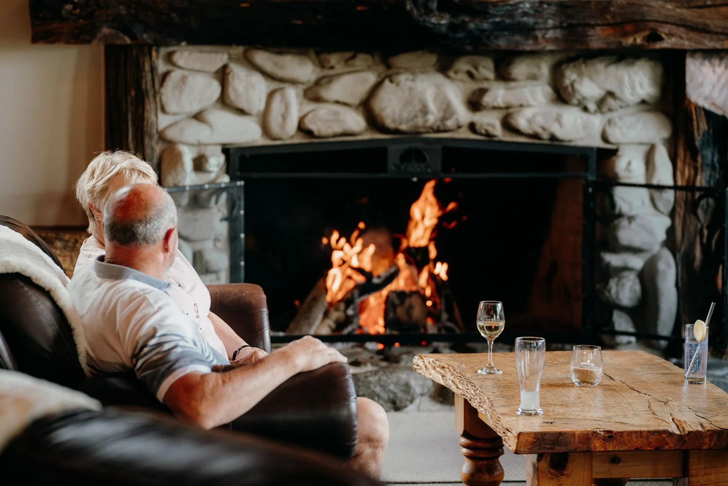 guests enjoying the ambiance of the open fire at makoura lodge country venue