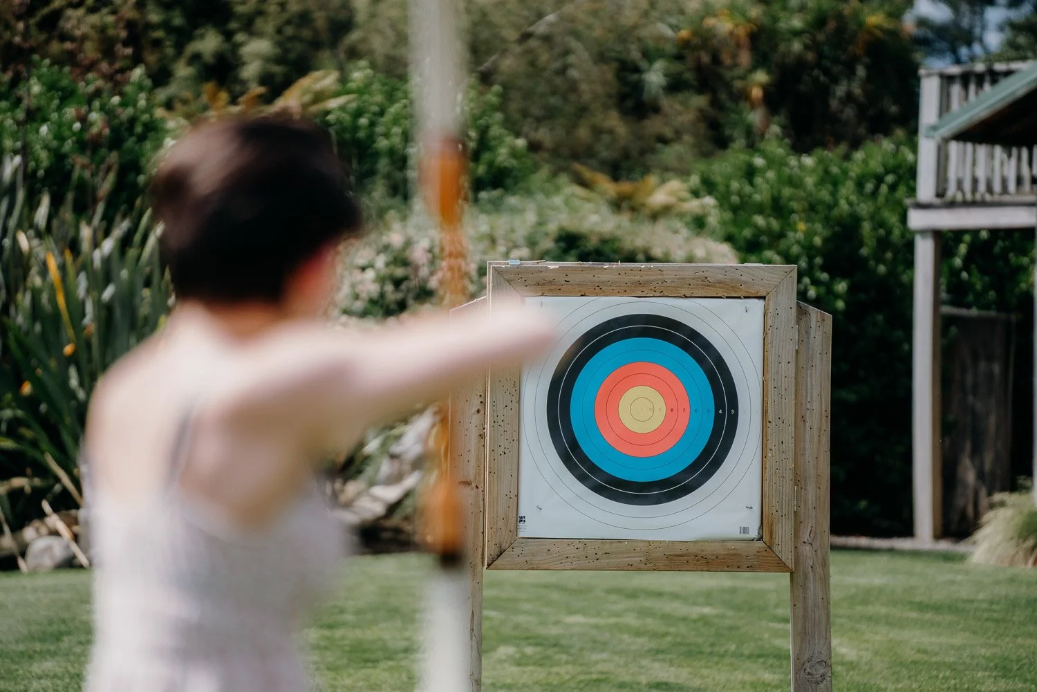 Girl aiming at Archery board at Makoura Lodge event venue Manawatu