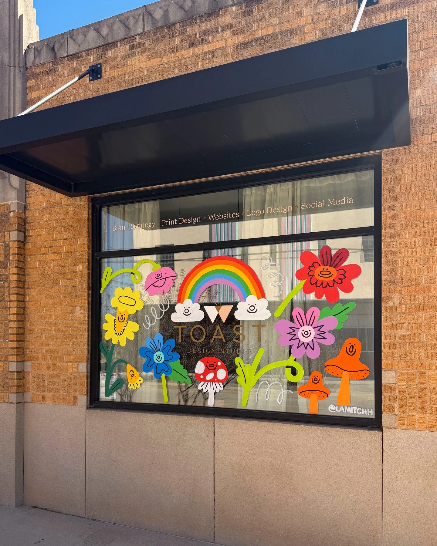 Spring has sprung at the Toast office in @westvillageokc, and we are obsessed with the whimsical window @lamitchh painted for us! 😍 Her window designs bring so much color and joy to our little corner of the world 🌷🌈🍄
