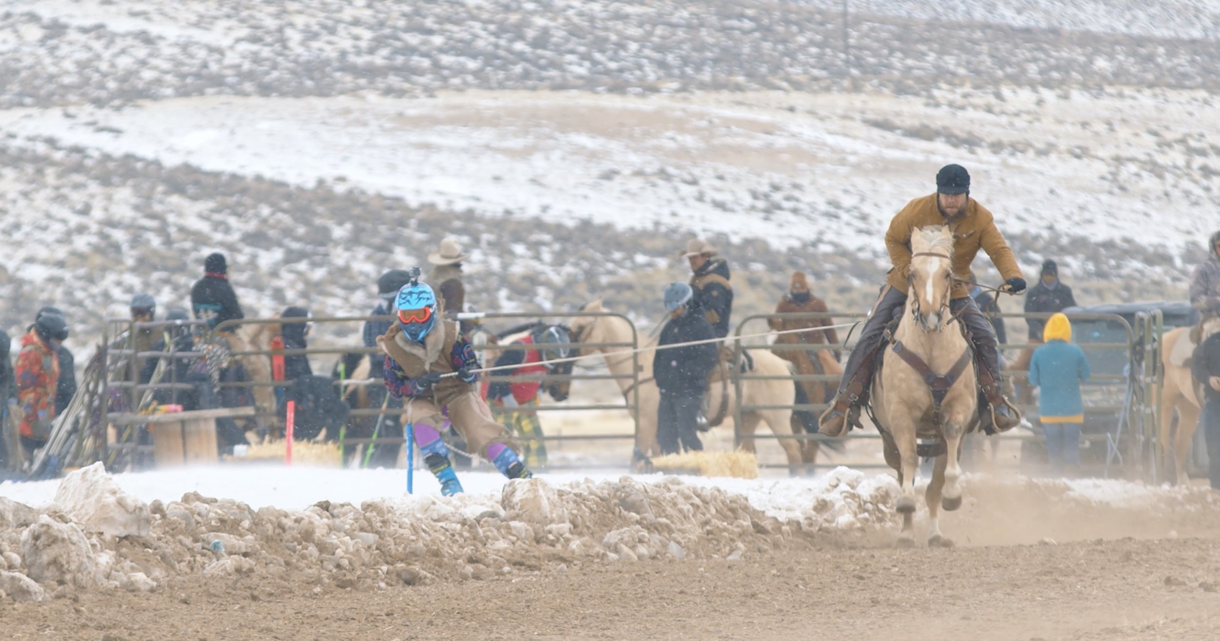 Skijoring competition with skier being pulled by horse, snowy background, spectators watching