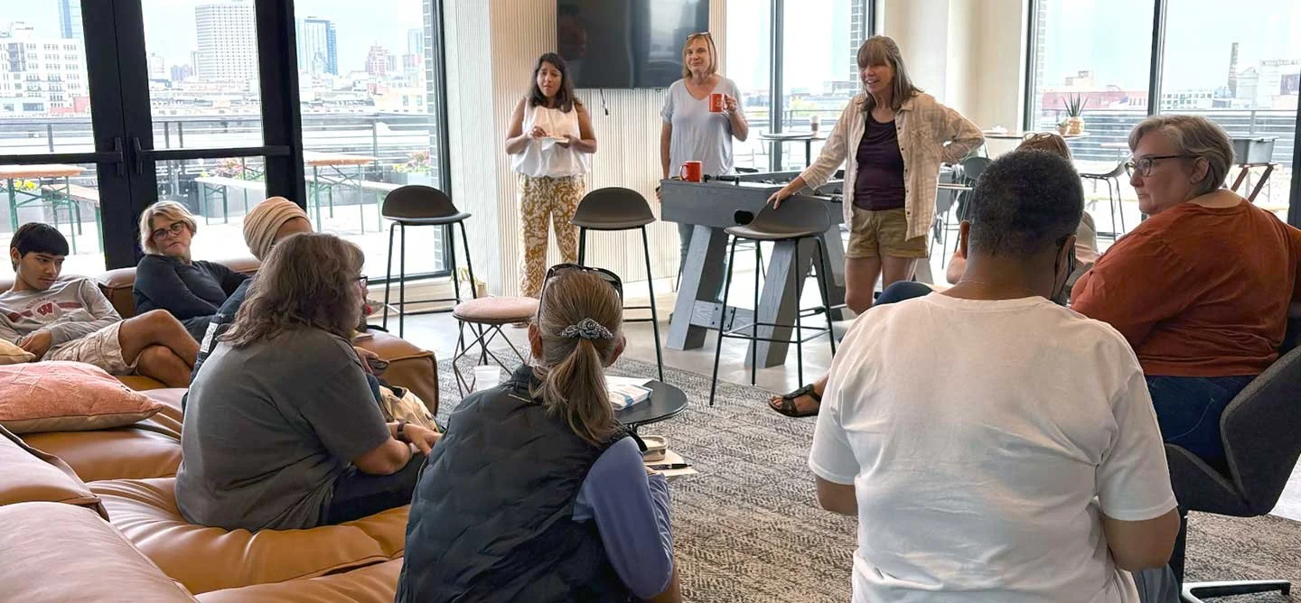 Parents and caregivers gather for a Brilliant Mornings discussion, connecting and sharing support in a welcoming community space at IOB.