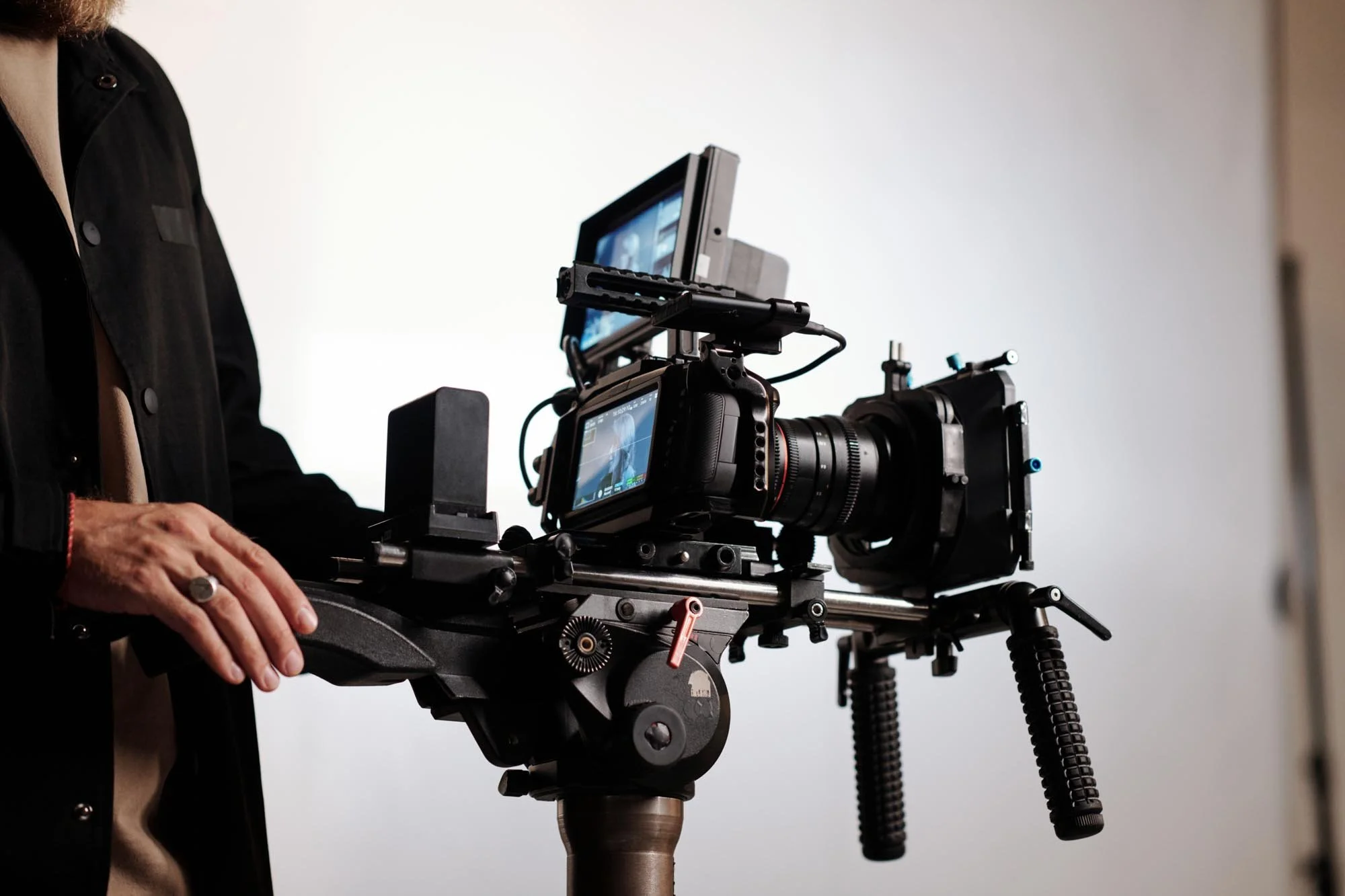 A professional cinema camera rig operated by a videographer in a Montreal studio, illustrating high-end gear that impacts production costs.