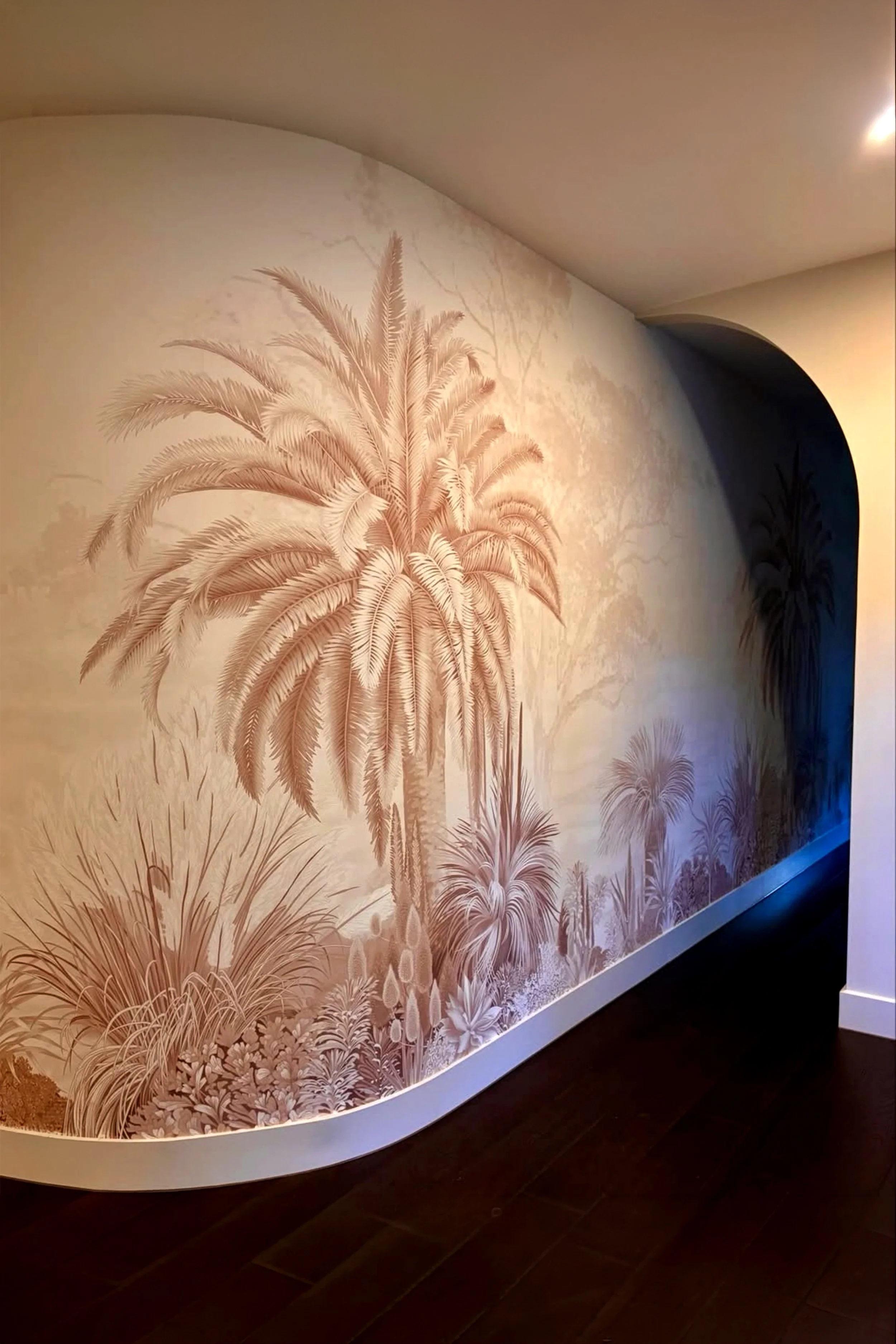 Our Sun-Blessed Lands Red Dust wallpaper mural on a curved wall – Australian landscape design in warm terracotta tones