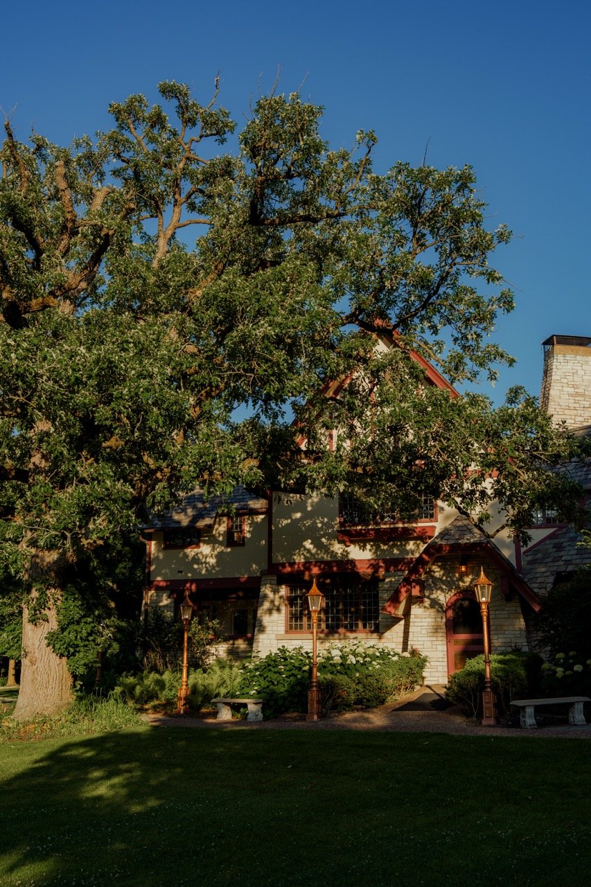 photo of the estate house with large tree covering it