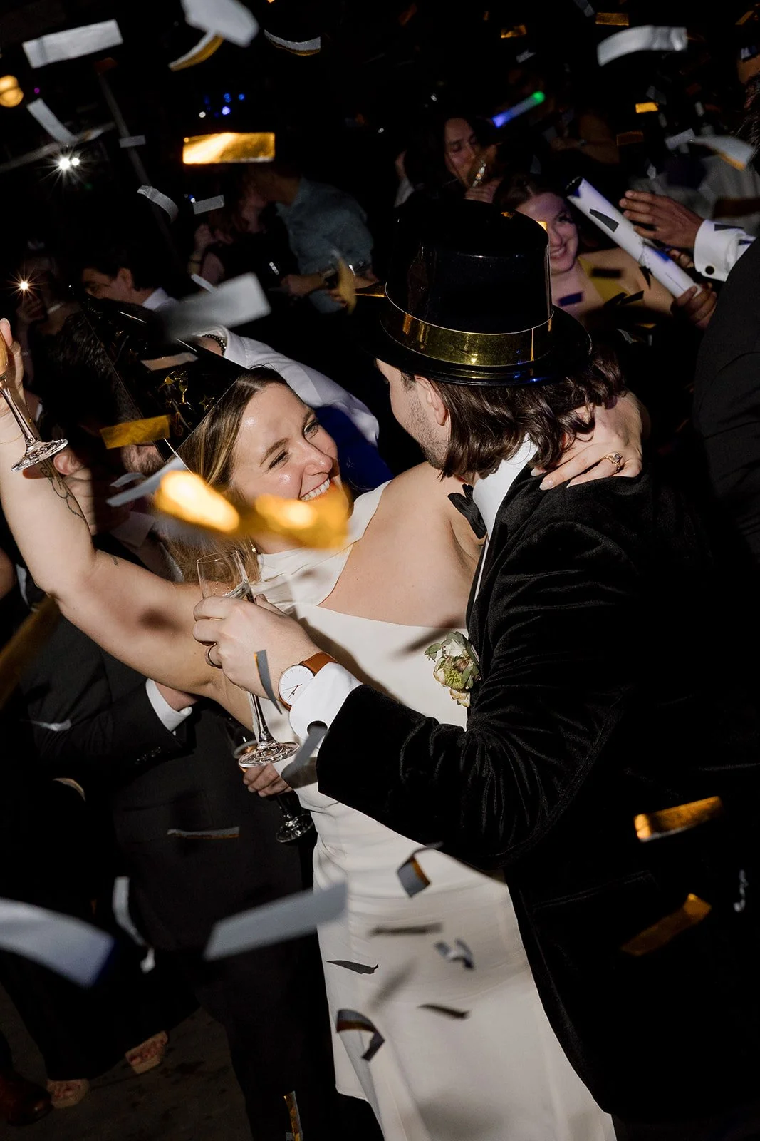 Bride smiling at groom confetti falling for midnight at New Year's Eve wedding at Wildman BT in Chicago