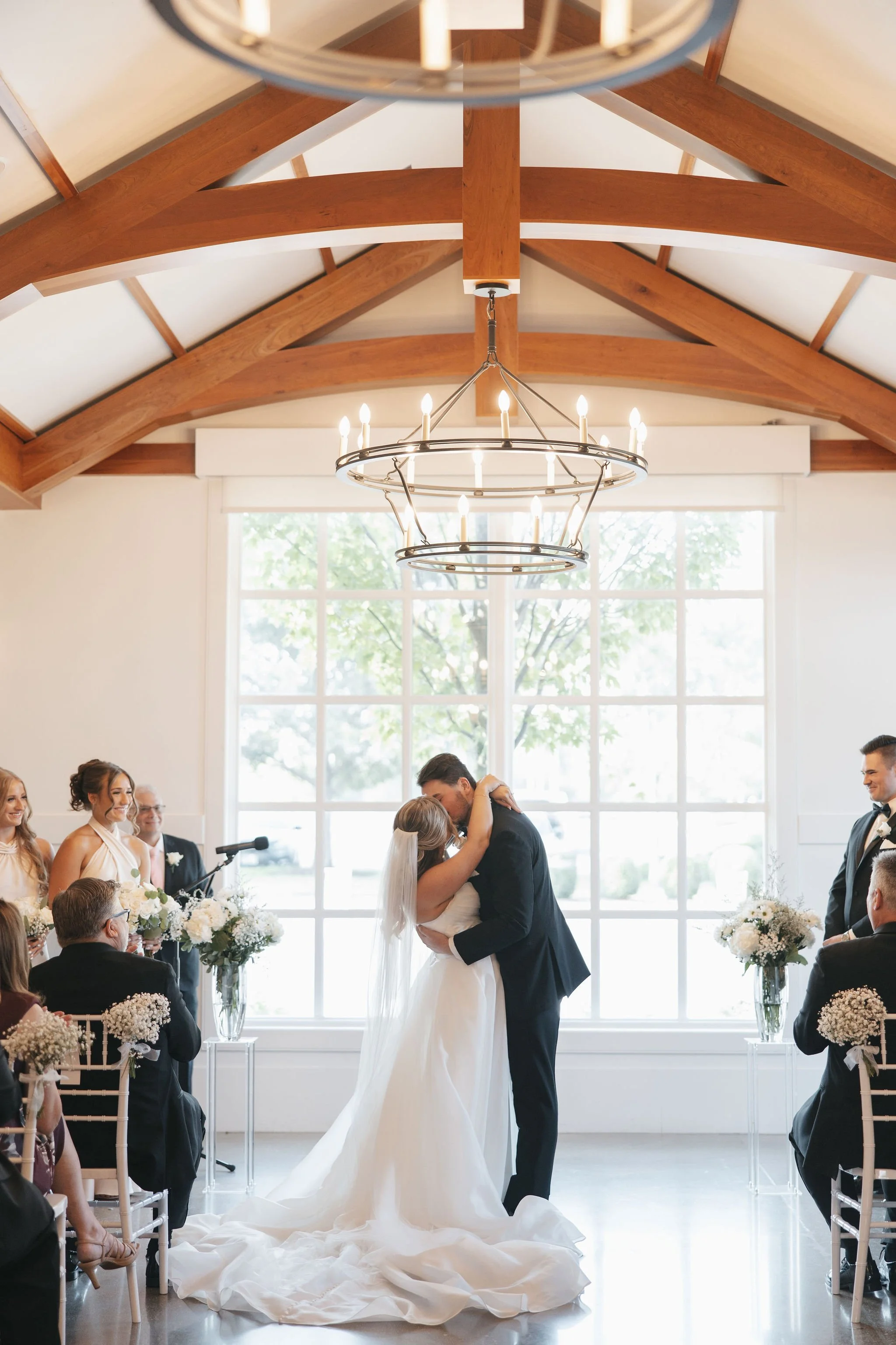 first kiss of bride and groom at wedding ceremony
