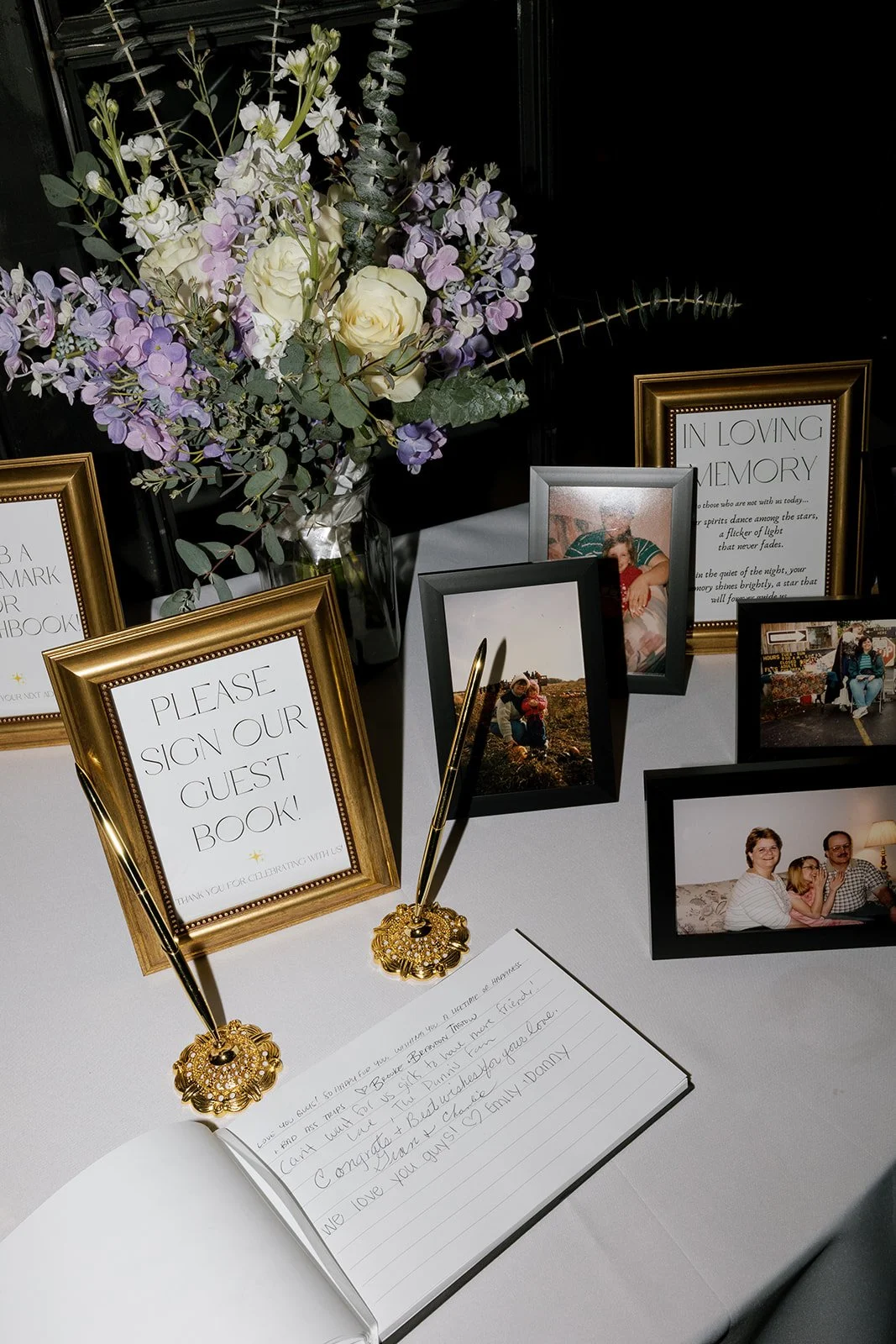 Wedding guest book with memory table photos and bouquet