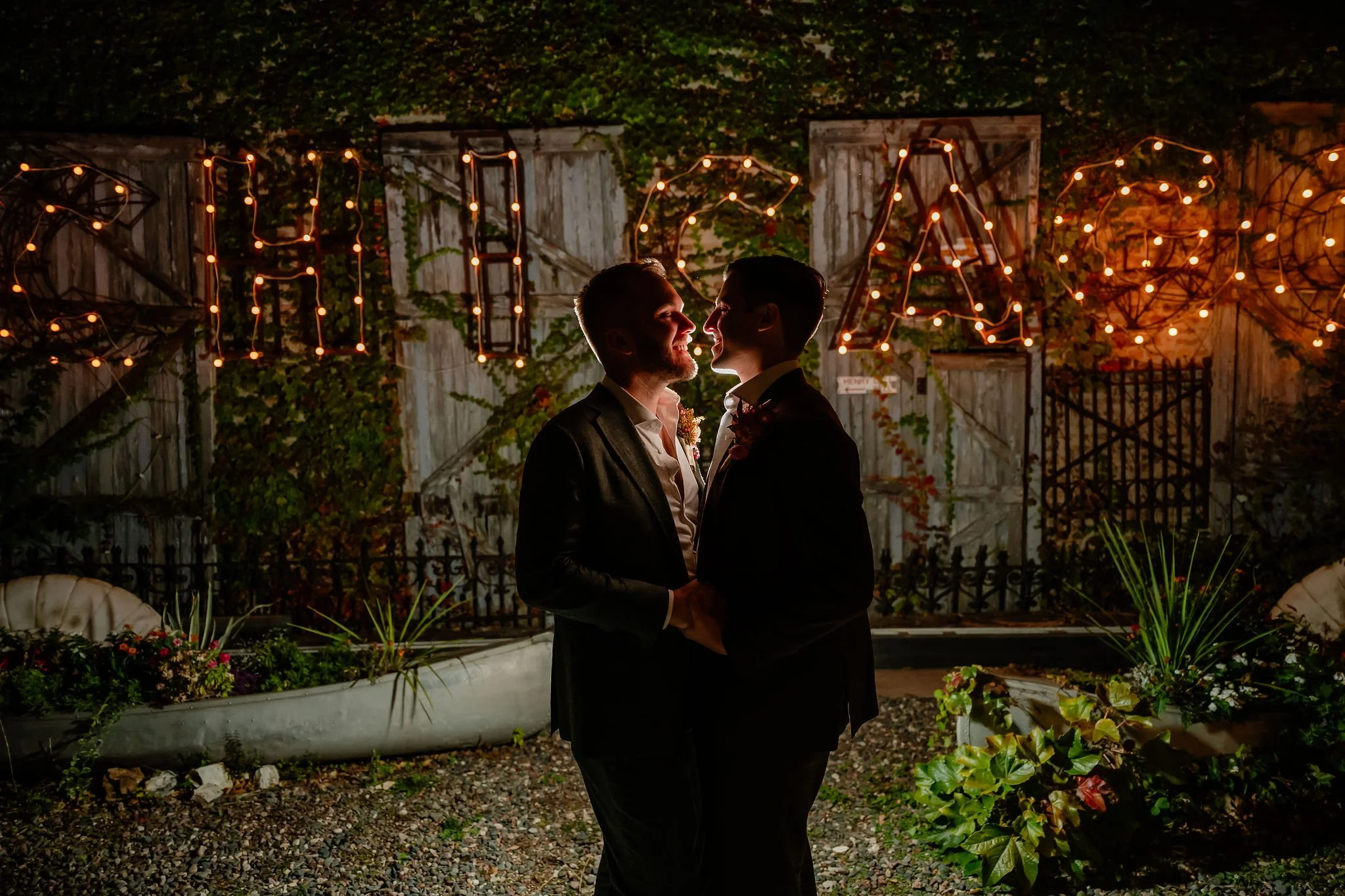 Light up Chicago word in lights with couple backlit holding each other and smiling