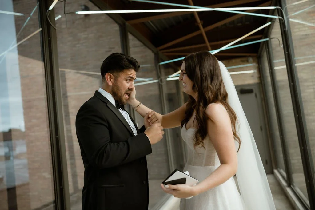 Chicago wedding couple reading vows and doing first look bride wiping groom's tears away