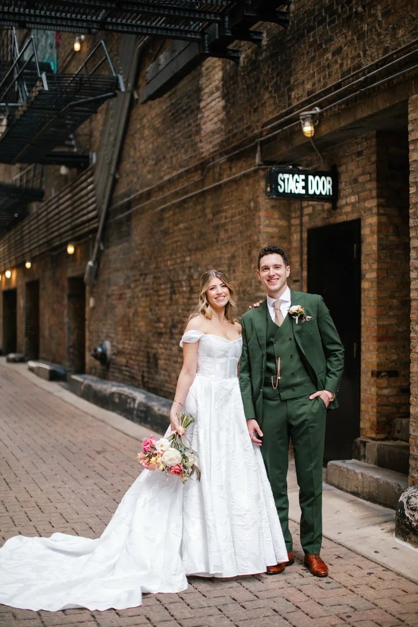 Bride and groom in alley by stage door in Theatre District in Chicago