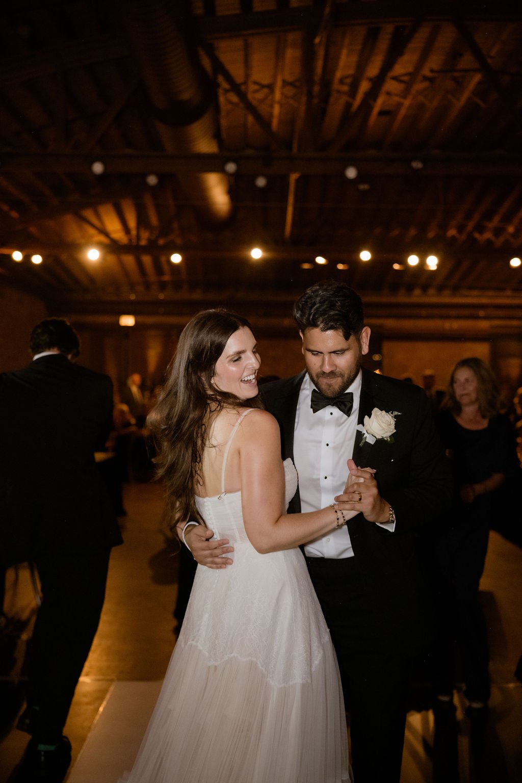 Bride and groom dancing together on dance floor at reception