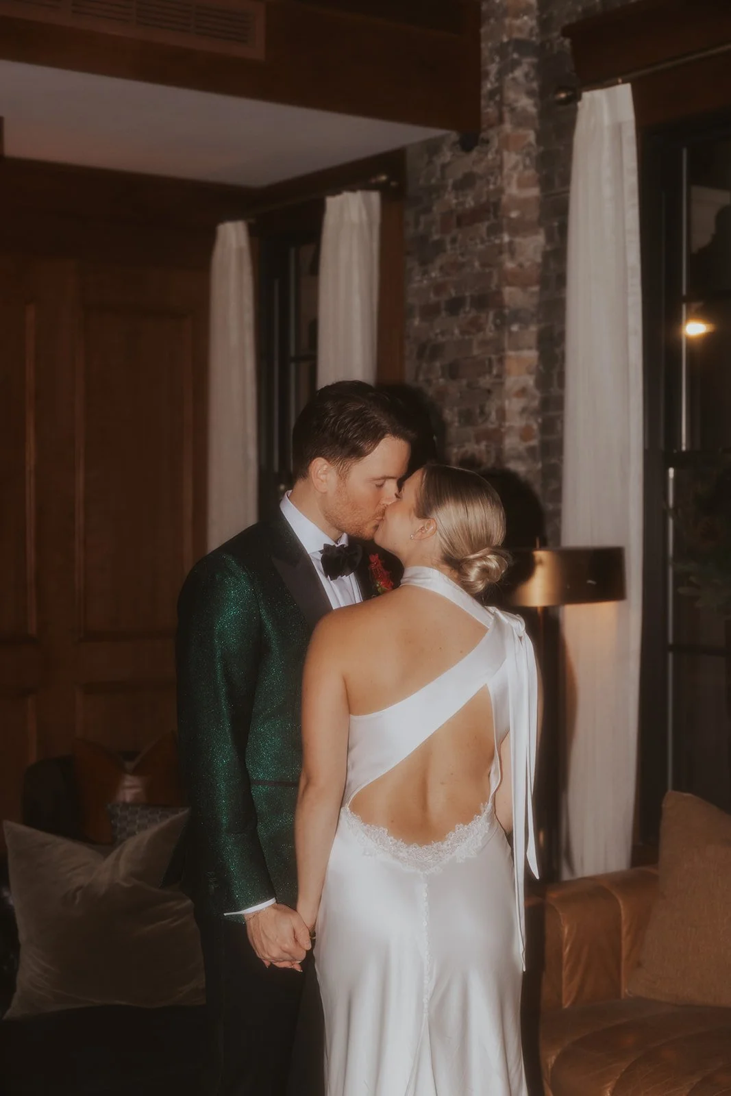 grainy film photos bride and groom kissing in Library at Salon 61 Events in Chicago