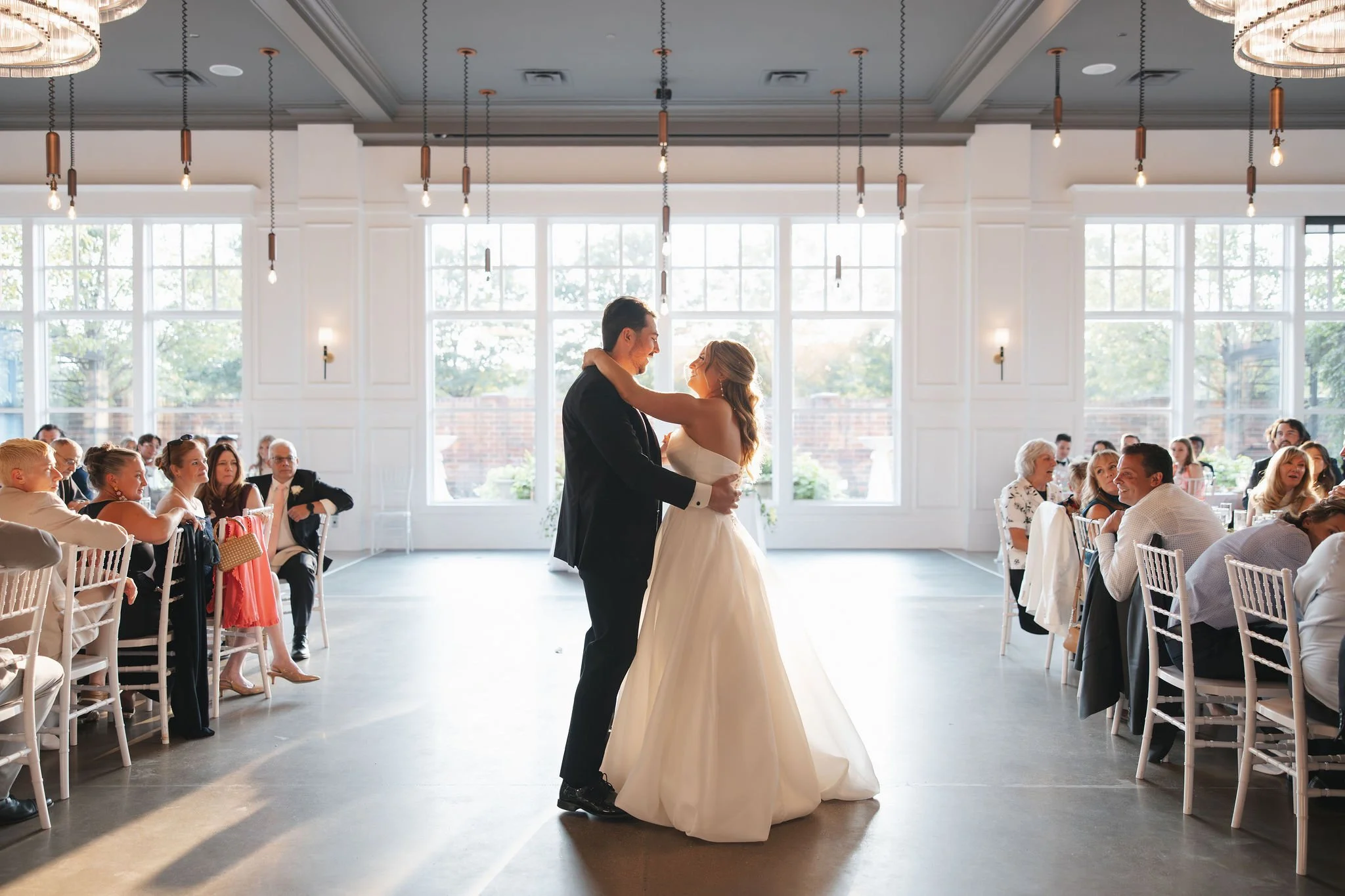 Bride and groom first dance in modern space called The Crawford in Naperville, IL
