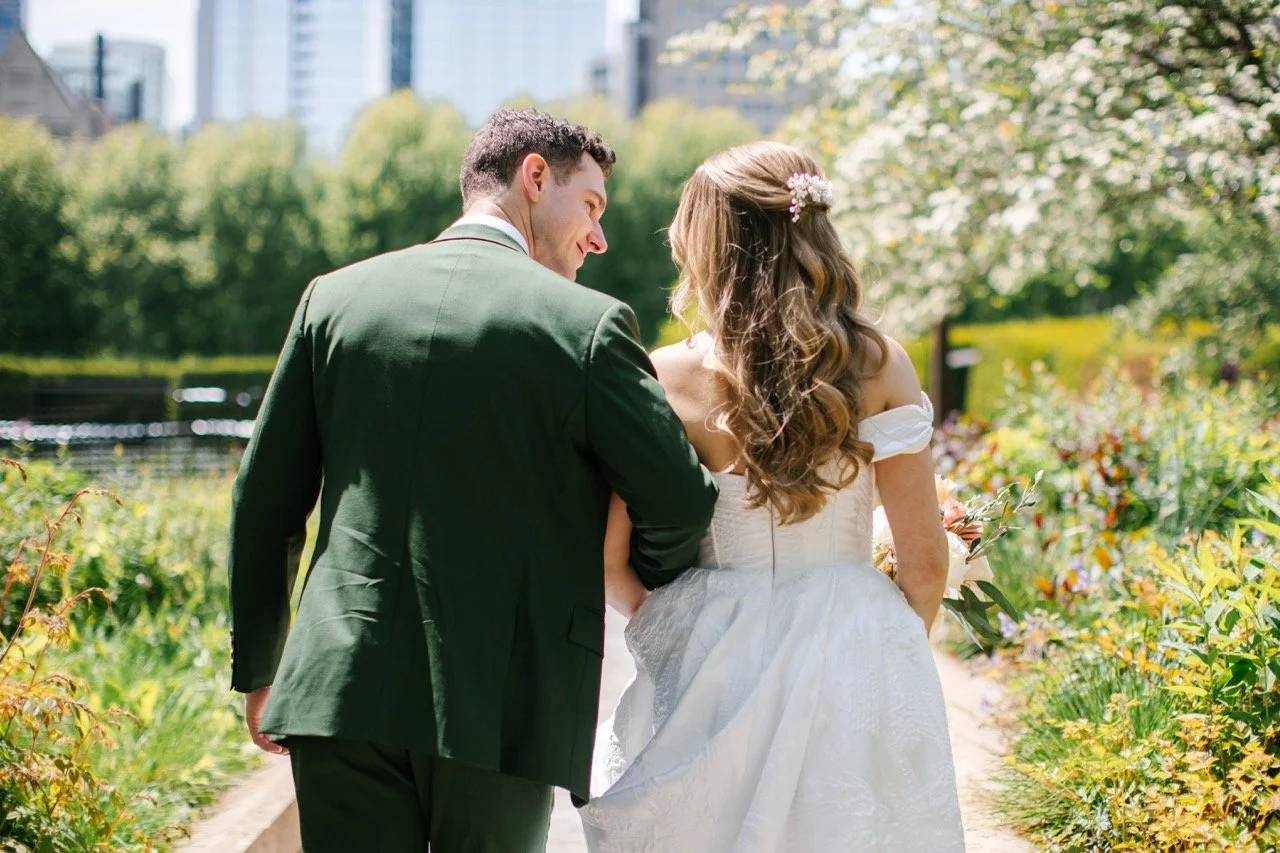 Bride and groom walking away in garden in Chicago for wedding