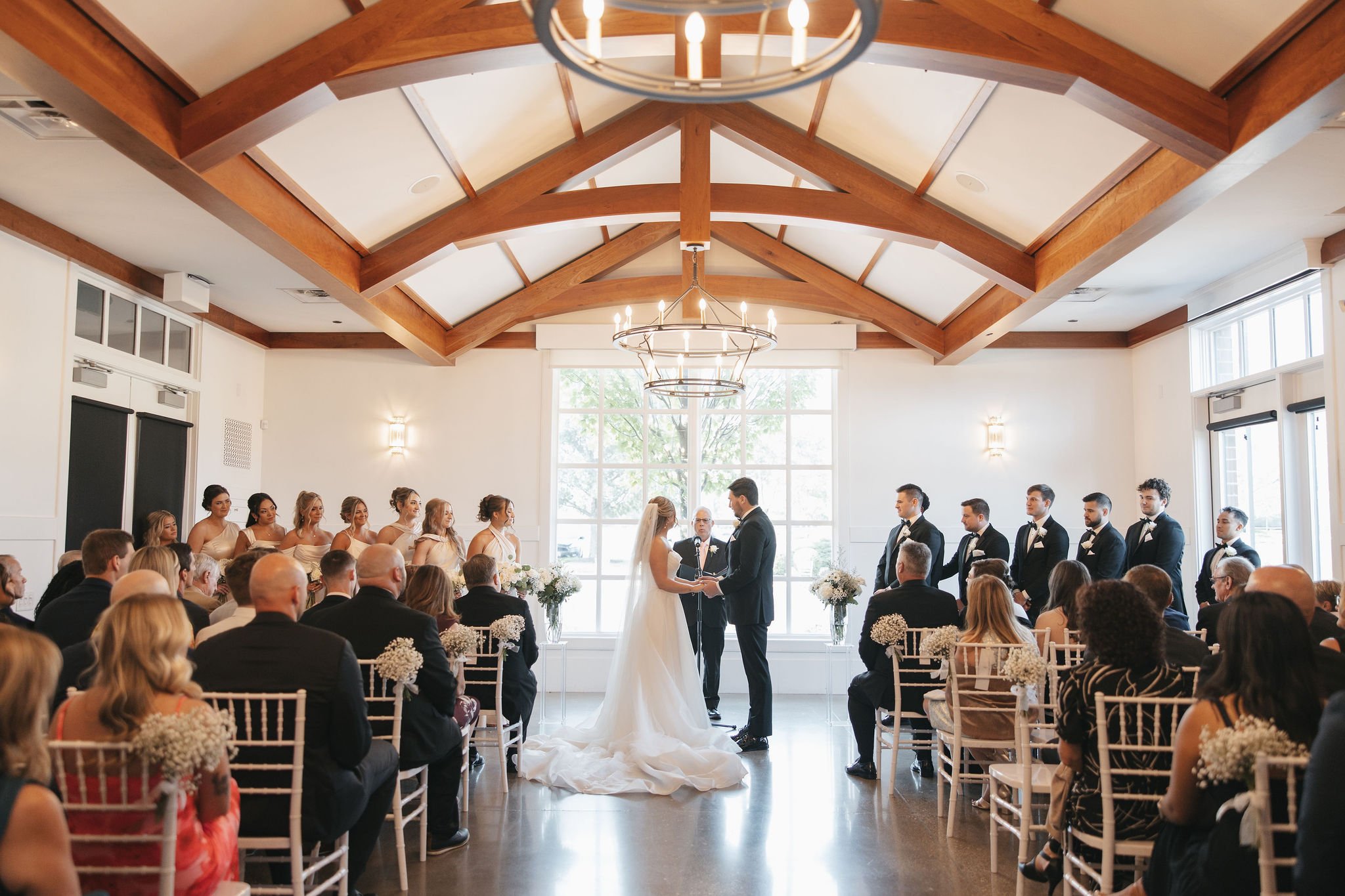 Wedding ceremony with bride and groom holding hands