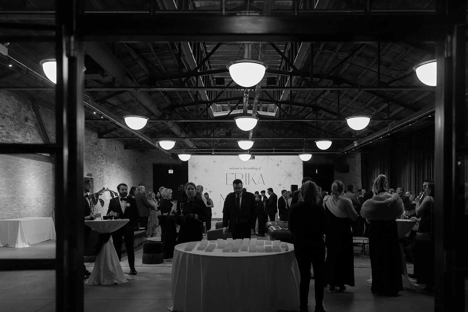 Place card table with guests mingling at cocktail hour wedding reception at Wildman BT in Chicago