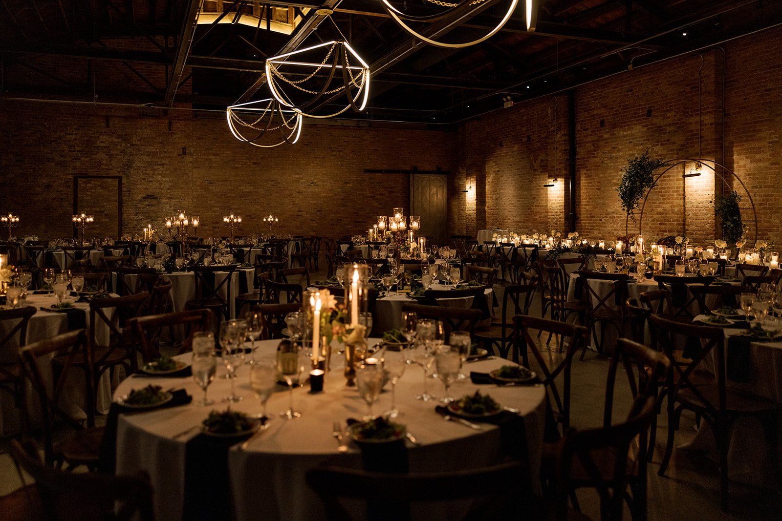 Wedding tables and chairs with moody lighting and candles