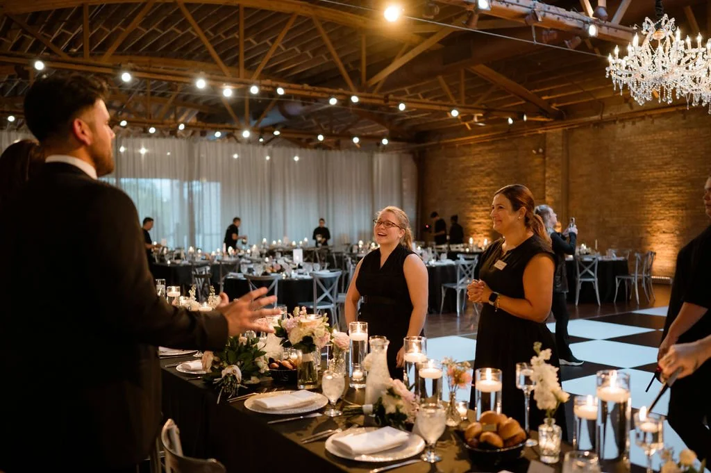 bride and groom thanking wedding planner or coordinator and caterer for setting everything up for them