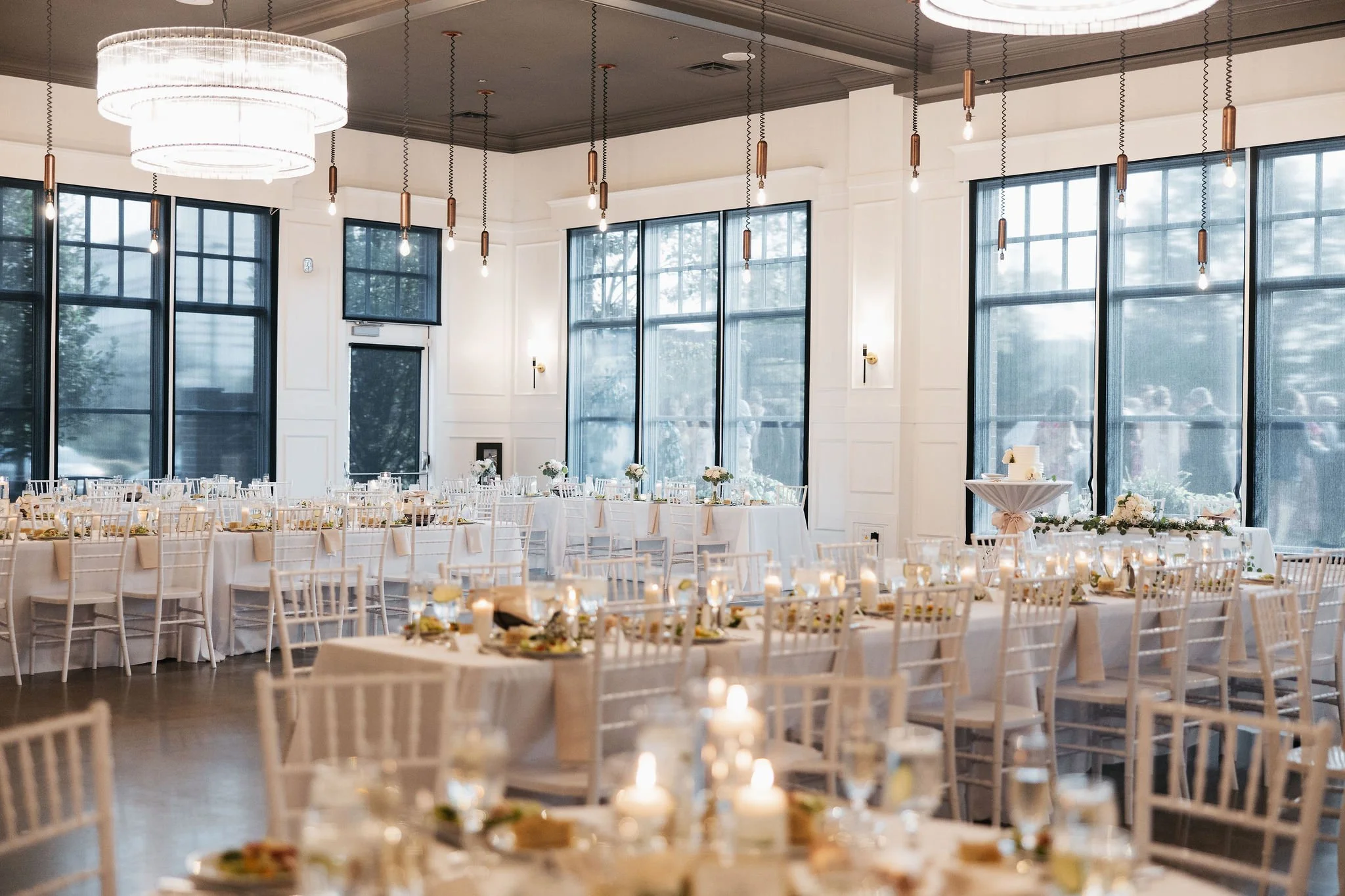 Full reception room shot with tables, chairs, decor, and salads on tables