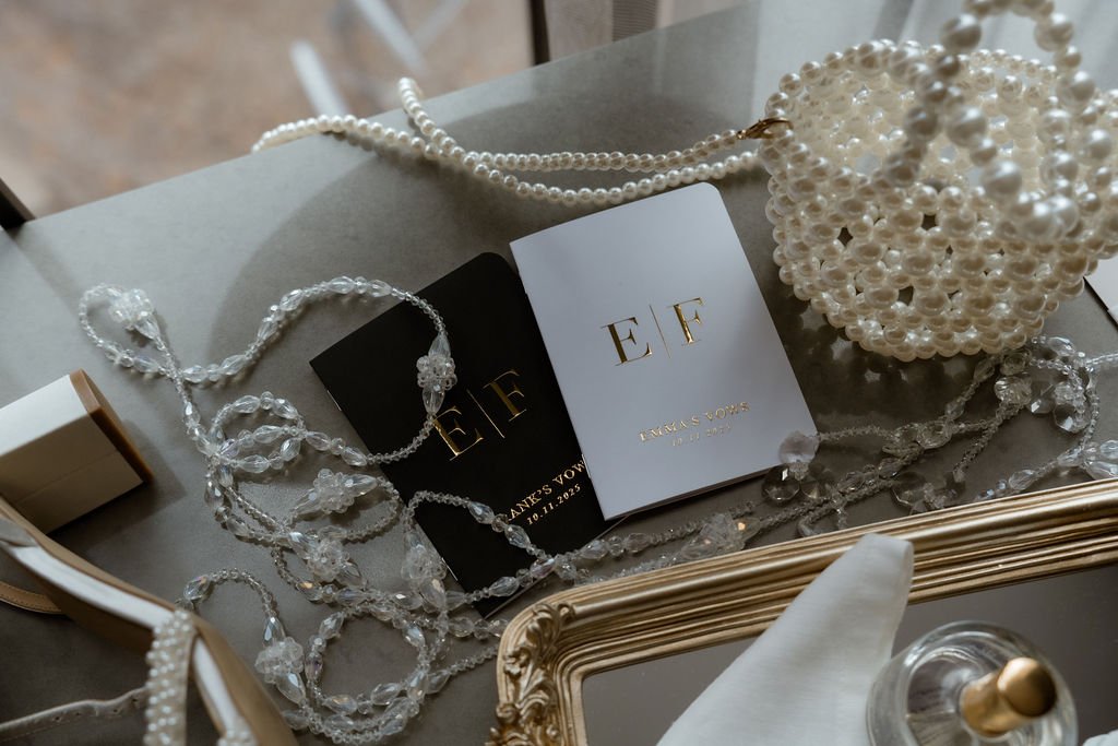 Chicago wedding vow books jewelry and purse details set as flatlay